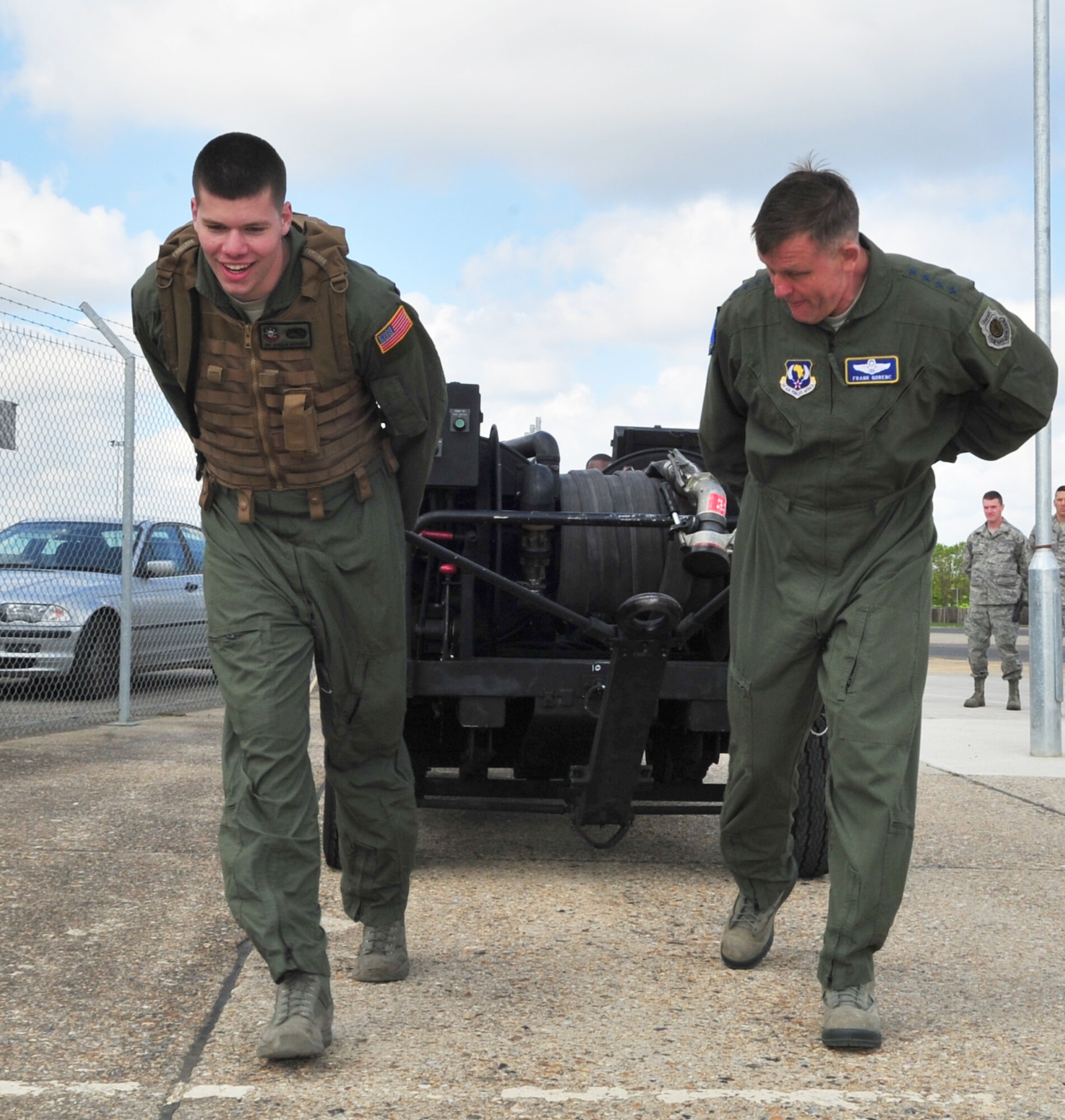 U.S. Air Force Airman 1st Class Thomas Mahoney, left, 100th Logistics Readiness Squadron Forward Area Refueling Point operator, and U.S. Air Force Gen. Frank Gorenc, U.S. Air Forces in Europe and Air Forces Africa commander, pull a forward area manifold cart April 14, 2014, during a visit to RAF Mildenhall, England. The 100th LRS FARP has the largest area of responsibility in the Air Force. The general visited several organizations during his time at RAF Mildenhall. (U.S. Air Force photo by Staff Sgt. Krystie Martinez/Released)