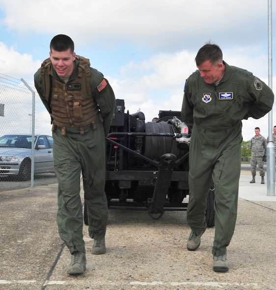 U.S. Air Force Airman 1st Class Thomas Mahoney, left, 100th Logistics Readiness Squadron Forward Area Refueling Point operator, and U.S. Air Force Gen. Frank Gorenc, U.S. Air Forces in Europe and Air Forces Africa commander, pull a forward area manifold cart April 14, 2014, during a visit to RAF Mildenhall, England. The 100th LRS FARP has the largest area of responsibility in the Air Force. The general visited several organizations during his time at RAF Mildenhall. (U.S. Air Force photo by Staff Sgt. Krystie Martinez/Released)