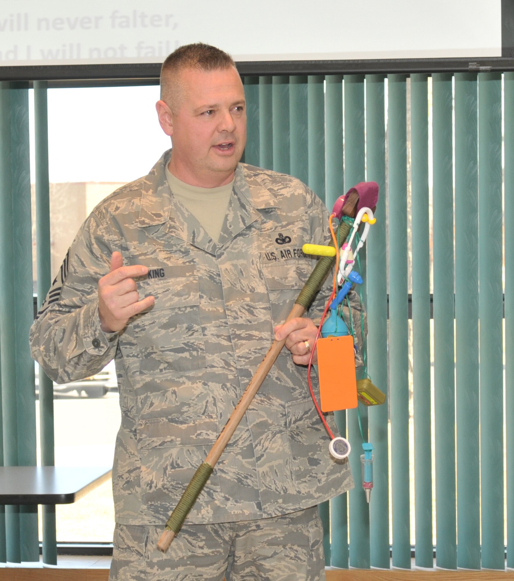 STRATTON AIR NATIONAL GUARD BASE, N.Y. -- Chief Master Sgt. Richard King, New York Air National Guard command chief, holds the spirit stick as he decides which section showed the most spirit during the promotion recogntion ceremony April 6, 2014. This is the second basewide ceremony for E-3s through E-6s held here. Chief Master Sgt. Amy Giaquinto, 109th Airlift Wing command chief, said she hopes the promotion recognition ceremonies will boost morale and promote wing cohesiveness. (Air National Guard photo by Staff Sgt. Benjamin German/Released)