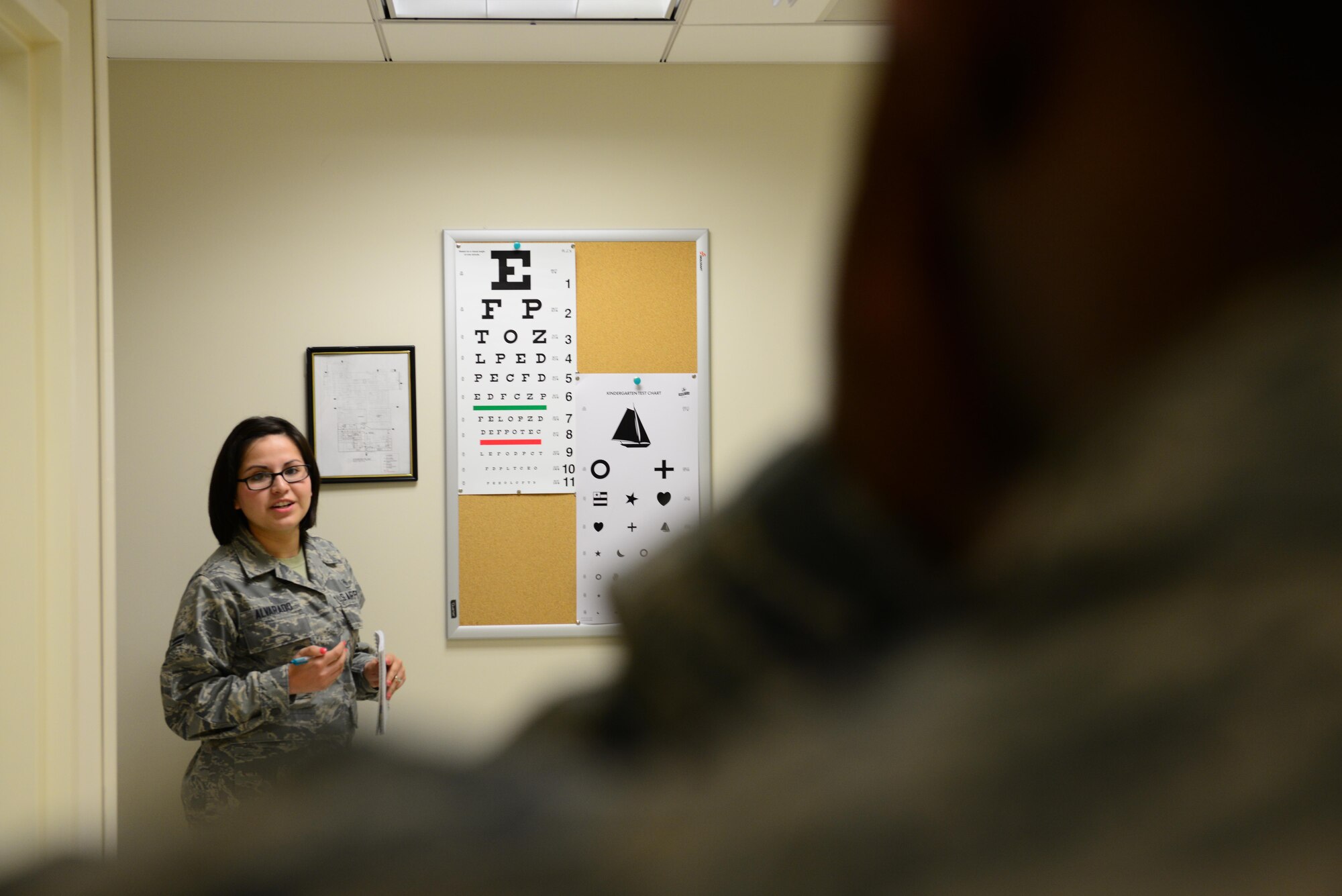 U.S. Air Force Airman 1st Class Evelyn Alvarado, 633rd Aerospace Medical Squadron public health technician, conducts a routine eye exam during a periodic health assessment at Langley Air Force Base, Va., April 8, 2014. The PHA is an assessment providing Airmen with preventive health services to maximize their wellbeing and to ensure their mobility readiness. Alvarado hails from El Paso, Texas. (U.S. Air Force photo by Airman 1st Class Kimberly Nagle/Released)