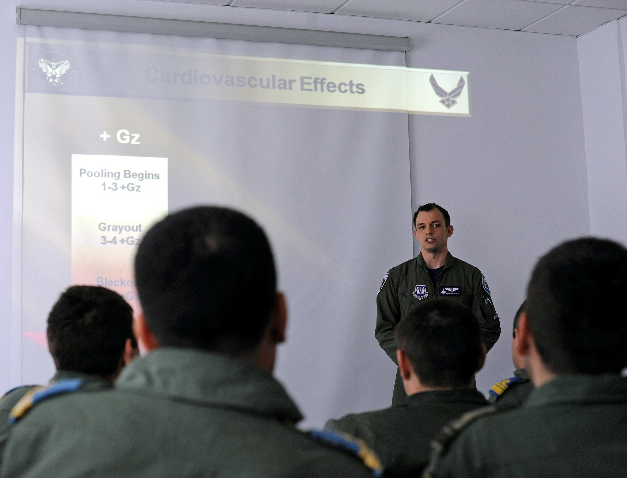 U.S. Air Force Capt. (Dr.) Rocky Jedick, 510th Fighter Squadron flight surgeon, provides a G-force briefing to Romanian air force MiG-21 Lancer pilots in preparation for F-16 Fighting Falcon training, at Campia Turzii, Romania, April 11, 2014. Romanian pilots will soon visit Brooks City-Base, Texas, for centrifuge training to prepare for the transition from the MiG-21 to the F-16. The Romanian government signed a contract with Portugal to acquire 12 F-16s to replace their MiG-21s. (U.S. Air Force photo/Staff Sgt. R.J. Biermann)