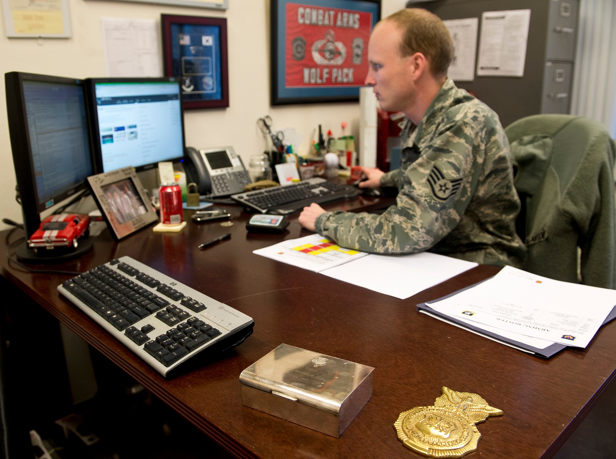 U.S. Air Force Staff Sgt. Ryan Silk, 703rd Munitions Support Squadron combat arms NCO in charge and Woodbury, Vt. native, updates records in his office at Volkel Air Base, the Netherlands, April 2, 2014. Silk, a fourth generation military member, also coordinated with the host nation to integrate U.S. personnel into Volkel’s Dutch shooting team, which was awarded second place in this year’s annual competition against all other Dutch Forces. (U.S. Air Force photo by Staff Sgt. Chad Warren/Released)