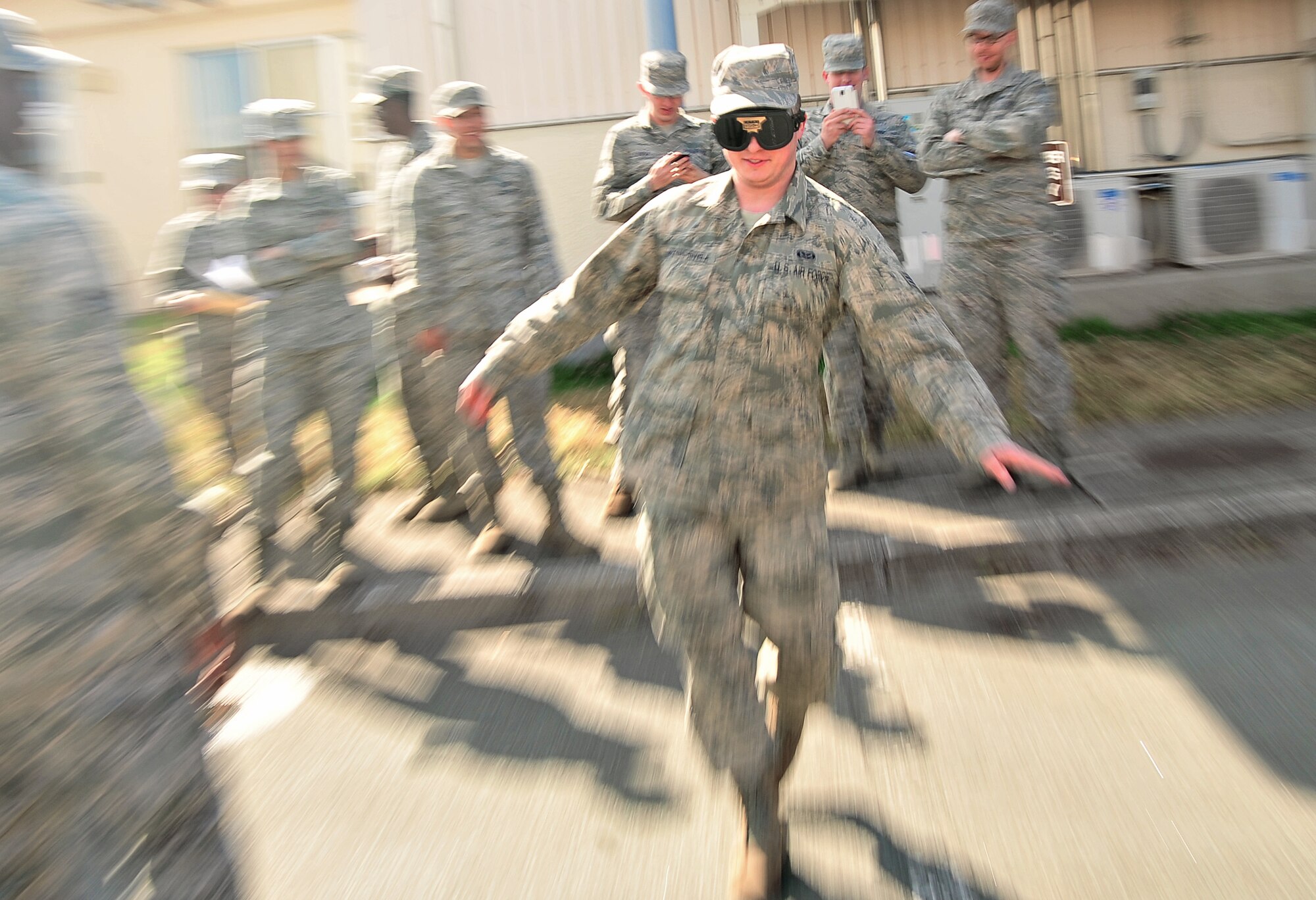 U.S. Air Force Senior Airman Steven Lumpkins-Rivela, 35th Civil Engineer Squadron structures journeyman, attempts to keep his balance while wearing drunken goggles during an alcohol awareness event at Misawa Air Base, Japan, April, 11, 2014. As part of Misawa’s Resilient Airman Day, the Alcohol and Drug Abuse Prevention and Treatment Program invited Airmen to take part in their alcohol awareness event and demonstrated to individuals what it feels like to have a high blood alcohol content level. (U.S. Air Force photo/Senior Airman Jose L. Hernandez-Domitilo)