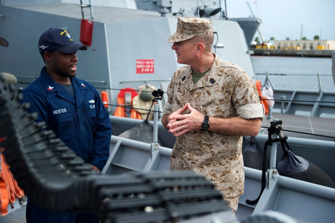 Marine Corps Sgt. Maj. Bryan B. Battaglia, right, senior enlisted advisor to the chairman of the Joint Chiefs of Staff, talks to Navy Chief Petty Officer 3rd Class Hester about the capabilities of the USS Zephyr on Naval Station Mayport, Fla., April 14, 2014.