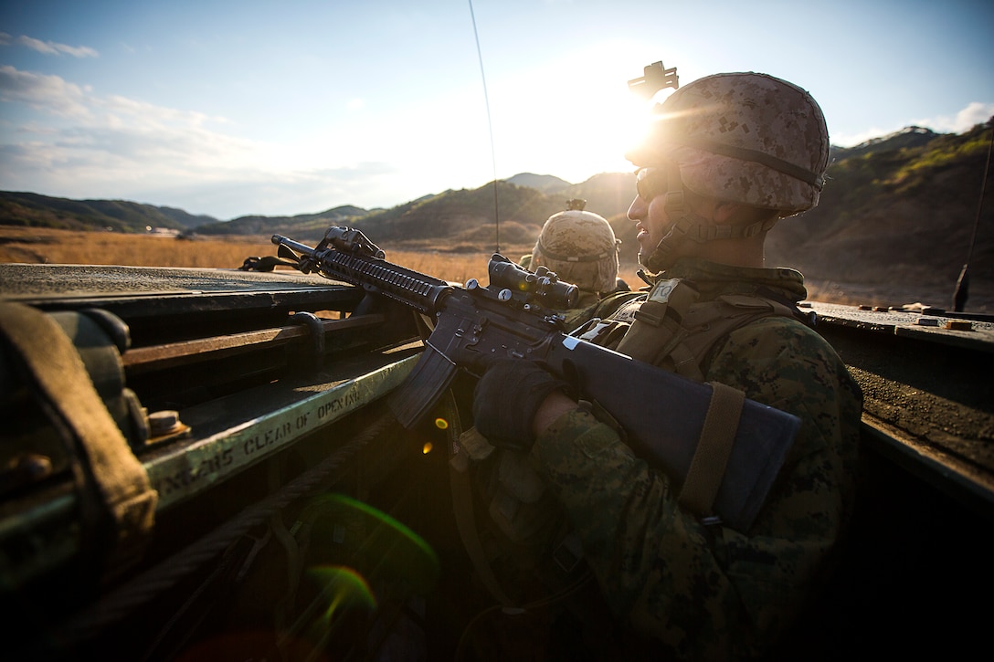 Lance Cpl. Juan C. Cazares, a rifleman with Company E., Battalion Landing Team 2nd Battalion, 5th Marines, Regimental Landing Team 31, 3d Marine Expeditionary Brigade, and a native of Bakersfield, Calif., provides security from the top of an amphibious assault vehicle during a combined arms, live-fire exercise (CALFEX) as part of Exercise Ssang Yong 2014 (SY14) here, April 4. The CALFEX incorporated all aspects of a Marine Air-Ground Task Force, sending a company of Marines into assault with direct fire support from AH-1W Super Cobra and UH-1Y Huey helicopters, AAV’s, Light Armored Vehicle-25’s and M777A1 Lightweight Howitzers. SY14 is conducted annually in the Republic of Korea to enhance interoperability between U.S. and ROK forces by performing a full spectrum of amphibious operations, while showcasing sea-based power projection in the Asia-Pacific. (Official U.S. Marine Corps photo by Lance Cpl. Andrew Kuppers)