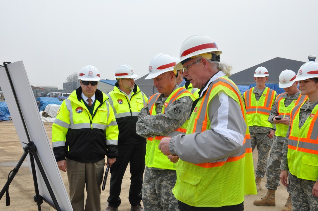 Michael P. Burke, a project engineer with the U.S. Army Corps of Engineers Far East District’s Medical Resident Office, briefs Pacific Ocean Division commander Maj. Gen. Rick Stevens on progress at the site of the future hospital and dental clinic on U.S. Army Garrison Humphreys March 26. Stevens was in Korea from his Hawaii headquarters to take part in a rehearsal of concept drill with senior military leaders from the peninsula to discuss a variety of issues, including the transformation of U.S. forces in the Republic of Korea. 