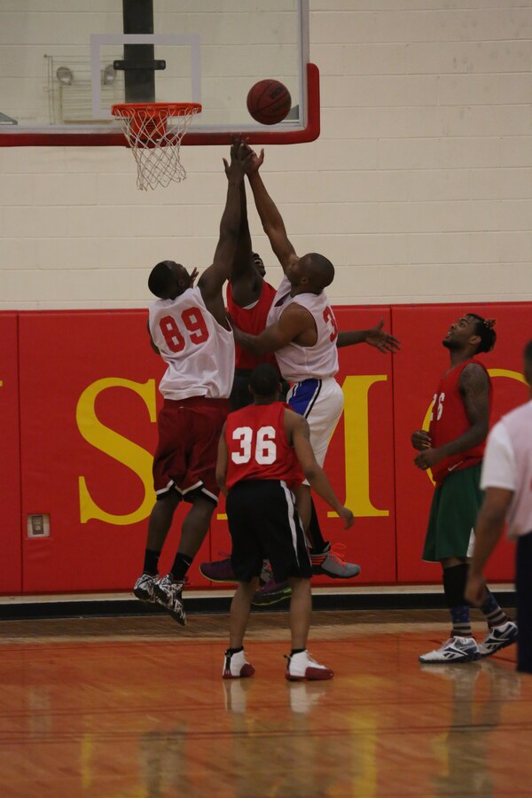 Players from the Quantico National and American Intramural Basketball Leagues jump for a rebound during the 2014 Quantico Intramural All-Star Basketball Game at Barber Physical Activity Center on April 7, 2014. The National League won the game by nine points with a final score of 51-42. 
