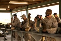 Marines with Alpha Company, 8th Engineer Support Battalion, 2nd Marine Logistics Group prepare ammunition prior to firing at a machine gun range aboard Camp Lejeune, N.C., April 14, 2014.  Approximately 33 Marines with Alpha Co. peppered targets with multiple machine guns in order to maintain proficiency with the weapons systems and build confidence. (U.S. Marine Corps photo by Cpl. Shawn Valosin)