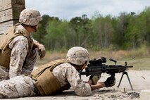 A Marine with Alpha Company, 8th Engineer Support Battalion, 2nd Marine Logistics Group fires an M-249 Squad Automatic Weapon under the supervision of a personnel safety officer at a machine gun range aboard Camp Lejeune, N.C., April 14, 2014.  Marines with the company also fired M-240B medium machine guns and M-2 .50-caliber machine guns to maintain proficiency with weapons systems they may utilize during deployments. (U.S. Marine Corps photo by Cpl. Shawn Valosin)