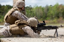 A Marine with Alpha Company, 8th Engineer Support Battalion, 2nd Marine Logistics Group fires an M-240B machine gun while a personnel safety officer feeds ammunition at the SR-8 range aboard Camp Lejeune, N.C., April 14, 2014.  Marines with Alpha Co. received courses on the M-249 Squad Automatic Weapon, M-240B and M-2 .50-caliber weapons systems prior to firing the weapons to build confidence and maintain proficiency. (U.S. Marine Corps photo by Cpl. Shawn Valosin)
