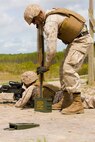 A personnel safety officer readies ammunition for a Marine with Alpha Company, 8th Engineer Support Battalion, 2nd Marine Logistics Group on the firing line at the SR-8 range aboard Camp Lejeune, N.C., April 14, 2014. The training helped the Marines learn how to release accurate, controlled bursts of machine-gun fire under the guidance of safety officers who provided feedback on the Marines’ performance. (U.S. Marine Corps photo by Cpl. Shawn Valosin)