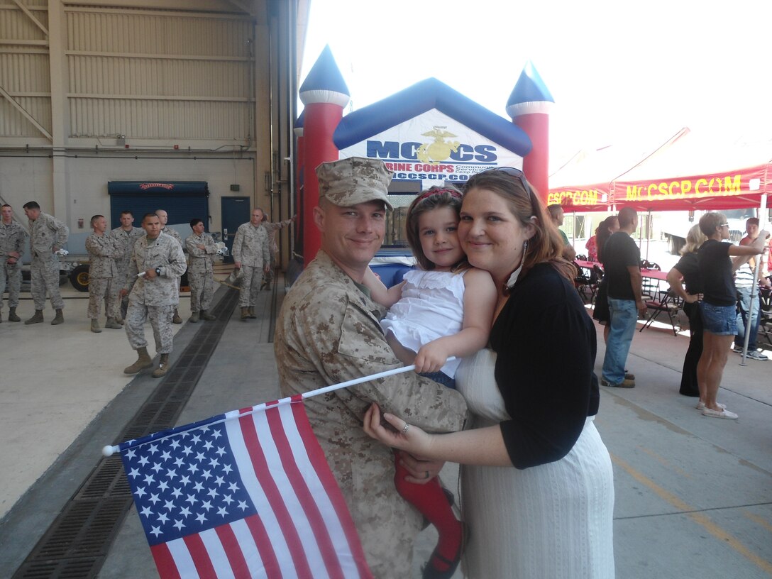 Patricia Walker stands with her daughter and husband, Sgt. Mark Walker, an airframe structure and hydraulic mechanic with Marine Light Attack Helicopter Squadron 369, after he returned from deployment aboard Marine Corps Base Camp Pendleton, Calif.