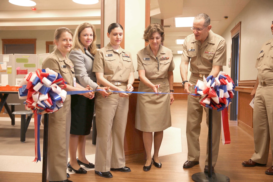 Left to right: Cmdr. Ingrid Sheldon, president of the medical staff, Ameliann Williams, director of mental health, Navy Lt. Jacqueline Lopez, division officer for inpatient psychiatry unit, Navy Capt. Nancy Pearson, director of nursing services, and Navy Capt. David Lane, commanding officer, Naval Hospital Camp Lejeune, celebrate the grand reopening of the mental health unit during a ribbon cutting ceremony, Monday. The new renovations include expanding the capacity from 12 to 20 patients, the clinic meets all behavior health standards features the most up-to-date equipment. “This is another great step for this Naval Hospital,” said Brig. Gen. Robert F. Castellvi, commanding general Marine Corps Installations East, Marine Corps Base Camp Lejeune. “I couldn’t have been more excited last week as I toured this facility and saw how state of the art we are becoming.”