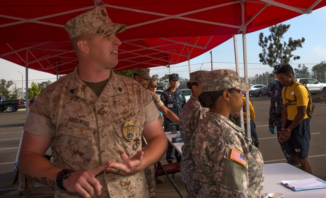 Sgt. Michael Sadowski, a correctional specialist with the Naval Consolidated Brig, explains what the processing stage of the brig can be like as a consequence to sexual assault during The Great Sexual Assault Prevention and Response Race aboard Marine Corps Air Station Miramar, Calif., April 15. The race was designed to teach Marines and Sailors about sexual assault so they are prepared to make better decisions and protect others.