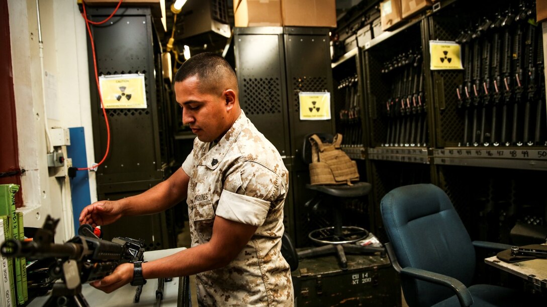 Sergeant Sigilfredo Garcia, small-arms technician, 15th Marine Expeditionary Unit, disassembles an M240B machine gun aboard Camp Pendleton, Calif., April 11, 2014. Garcia, 26, is from Watsonville, Calif. (U.S. Marine Corps photo by Cpl. Emmanuel Ramos/Released)