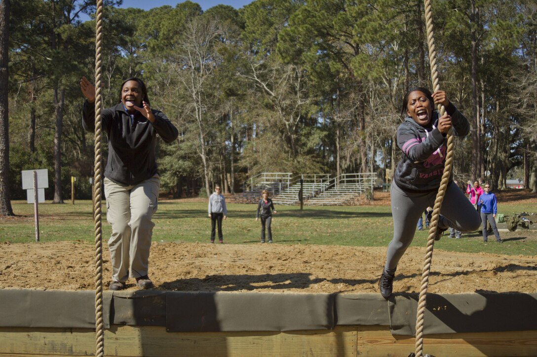 Michelle James, left, a guidance counselor at Maurice J. McDonough High School in Pomfret, Md., and Kari Mason, a guidance counselor at Charles H. Flowers High School in Springdale, Md., negotiate an obstacle on the confidence course during the second day of Recruiting Station Baltimore’s Educators Workshop at Marine Corps Recruit Depot Parris Island, S.C. The Educators Workshop is a four-day event that is intended to offer educators a practical knowledge of the Marine Corps and impress upon them the continual need to recruit highly qualified men and women. (U.S. Marine Corps photo by Sgt. Bryan Nygaard/Released)