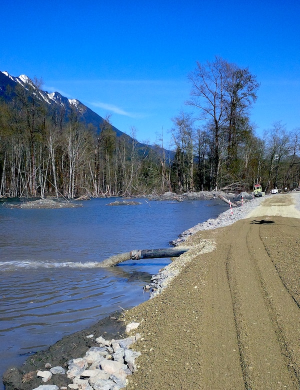 The Corps of Engineers runs a pump, which is installed near a temporary berm within the SR530 slide area.  The pumps are emptying an area previously inundated with water so search teams can enter the area and continue working.  Corps officials are now focusing efforts on raising the pictured berm an additional foot ahead of predicted rainfall. The additional height is expected to help reduce potential flooding risks, and the Corps is maintaining close coordination and communication with Snohomish County officials as recovery workers continue to search the area.  