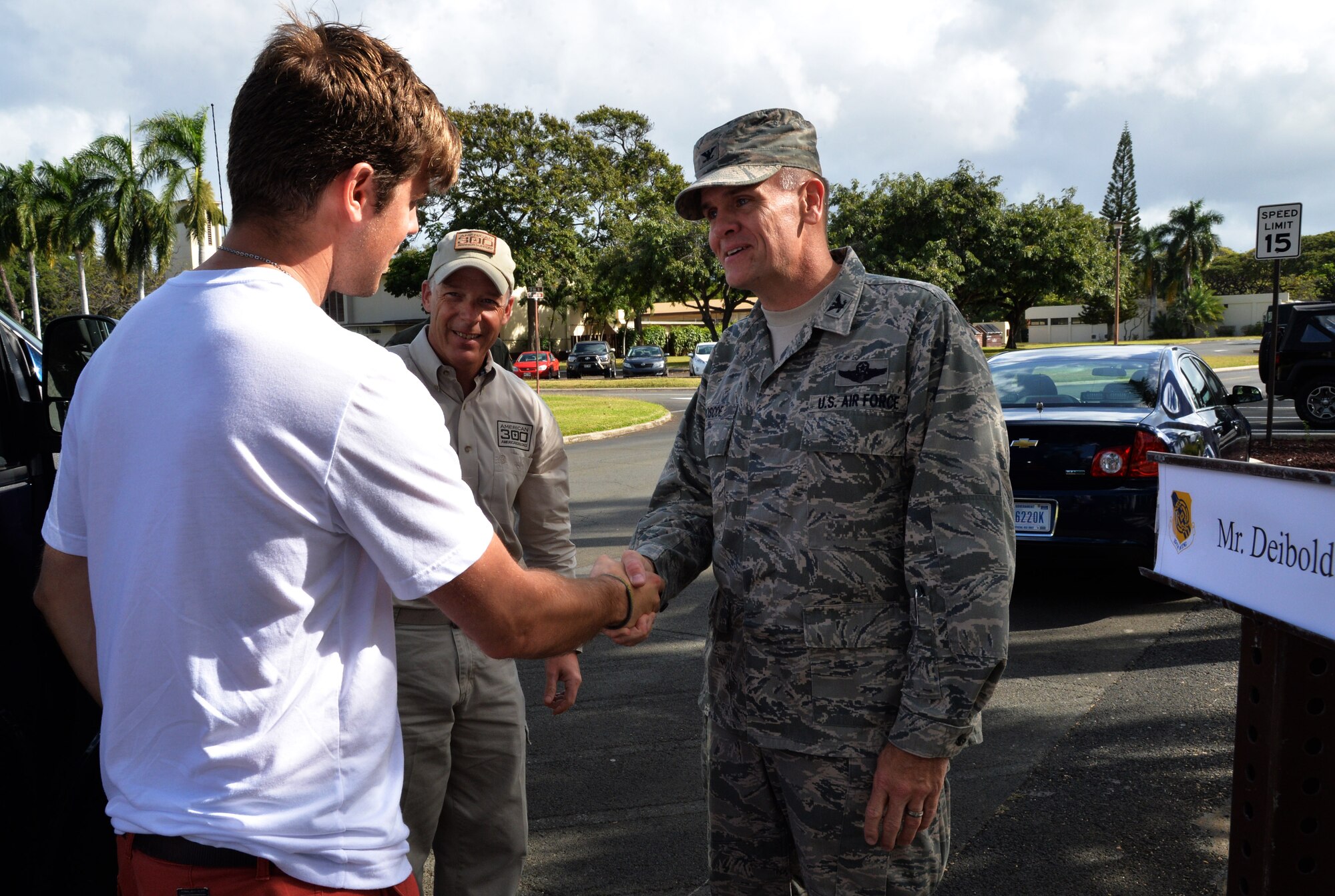 From left: U.S. Olympic snowboarder Alex Deibold (left) shakes hands with Col. Johnny Roscoe, 15th Wing commander, during a tour of the wing at Joint Base Pearl Harbor-Hickam, Hawaii, April 15, 2014. Deibold, a Sochi Olympic bronze medal winner, toured wing units and Airmen as part of a program sponsored by the 300 Warrior Support Organization. (U.S. Air Force photo/Staff Sgt. Alexander Martinez)