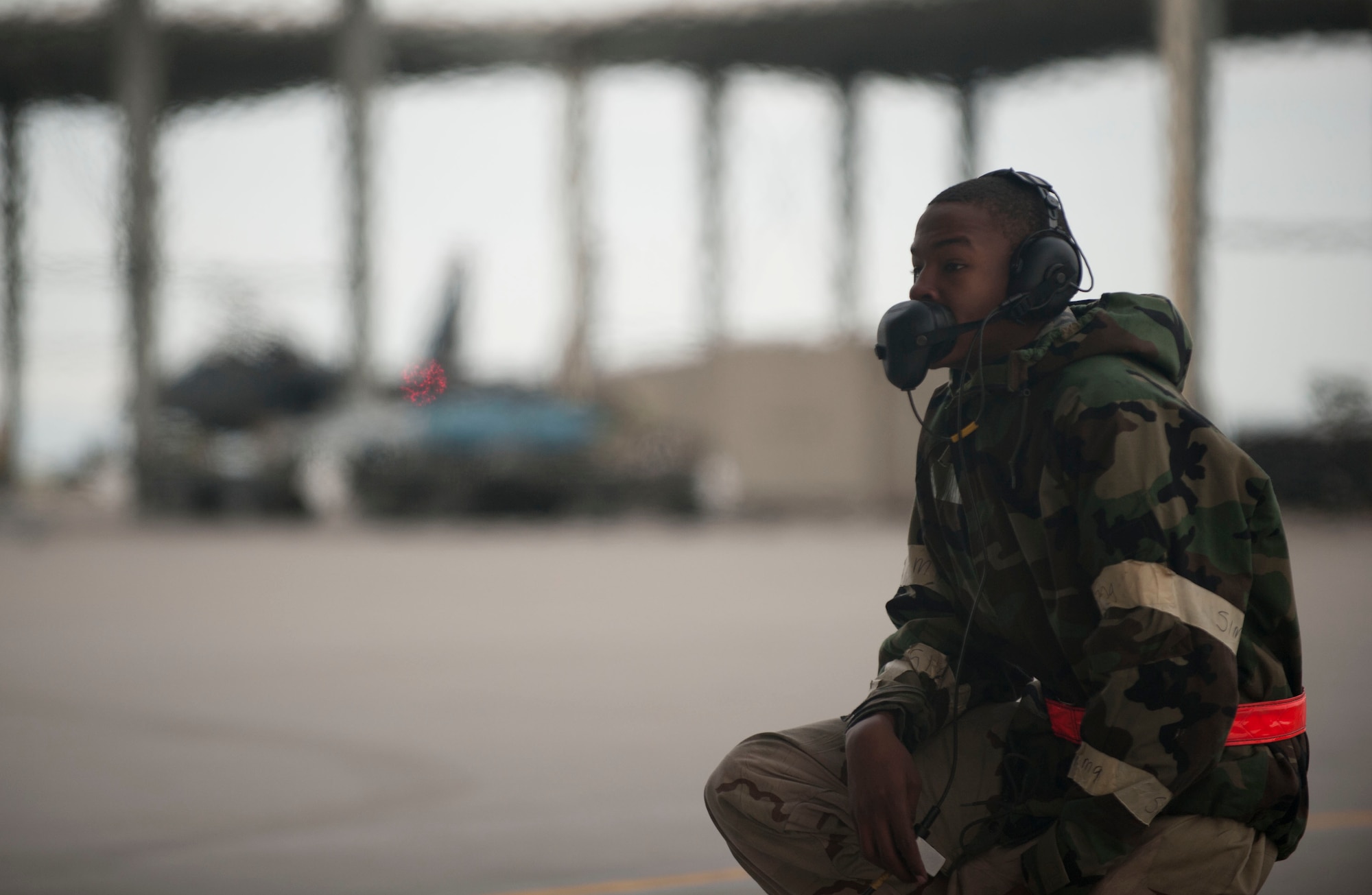 Airman 1st Class Dikembe Newton, 366th Air Maintenance Squadron crewchief, communicates with a pilot before takeoff April 16, 2014, Mountain Home Air Force Base, Idaho. Airmen at MHAFB participate in Sharpshooter 14-02, an exercise that tests Airmen’s abilities to work under simulated chemical attack. (U.S. Air Force photo by Airman 1st Class Malissa Lott/RELEASED)