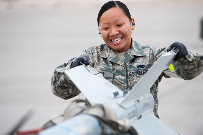 Senior Airman Khanh Mai, 757th Aircraft Maintenance Squadron, Eagle Aircraft Maintenance Unit load crew member, prepares inert munitions for loading during the quarterly load crew competition, April 11, 2014, at Nellis Air Force Base, Nev. The load crew competition between the various aircraft maintenance units helps ensure Airmen maintain their skills while also promoting friendly competition and camaraderie. (U.S. Air Force photo by Airman 1st Class Thomas Spangler)