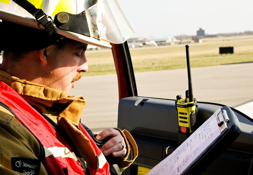 U.S. Air Force Tech. Sgt. Jeffrey Owens, a firefighter with the 182nd Civil Engineer Squadron, acts as the fire ground commander during a mass-casualty exercise in Peoria, Ill., April 12, 2014. An Illinois Air National Guard C-130 Hercules was used to imitate an aircraft crash with 50 casualties on a Gen. Wayne A. Downing Peoria International Airport runway. The airport hosted the tri-annual exercise to test its emergency protocols. Several emergency-response agencies, including the 182nd Civil Engineer Squadron fire department, also participated in the exercise to practice their procedures and training. (U.S. Air National Guard photo by Staff Sgt. Lealan Buehrer/Released)