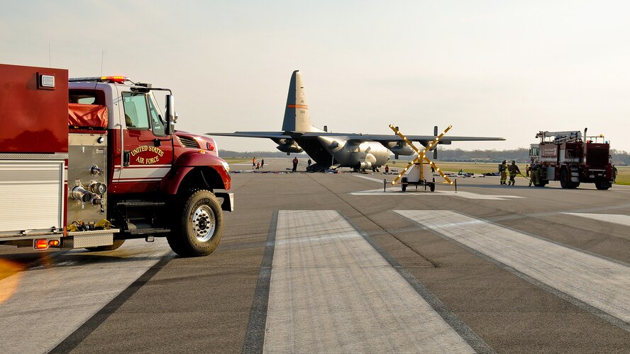 Firefighters with the 182nd Civil Engineer Squadron arrive at the scene of a simulated aircraft crash during a mass-casualty exercise in Peoria, Ill., April 12, 2014. An Illinois Air National Guard C-130 Hercules was used to imitate an aircraft crash with 50 casualties on a Gen. Wayne A. Downing Peoria International Airport runway. The airport hosted the tri-annual exercise to test its emergency protocols. Several emergency-response agencies, including the 182nd Civil Engineer Squadron fire department, also participated in the exercise to practice their procedures and training. (U.S. Air National Guard photo by Staff Sgt. Lealan Buehrer/Released)