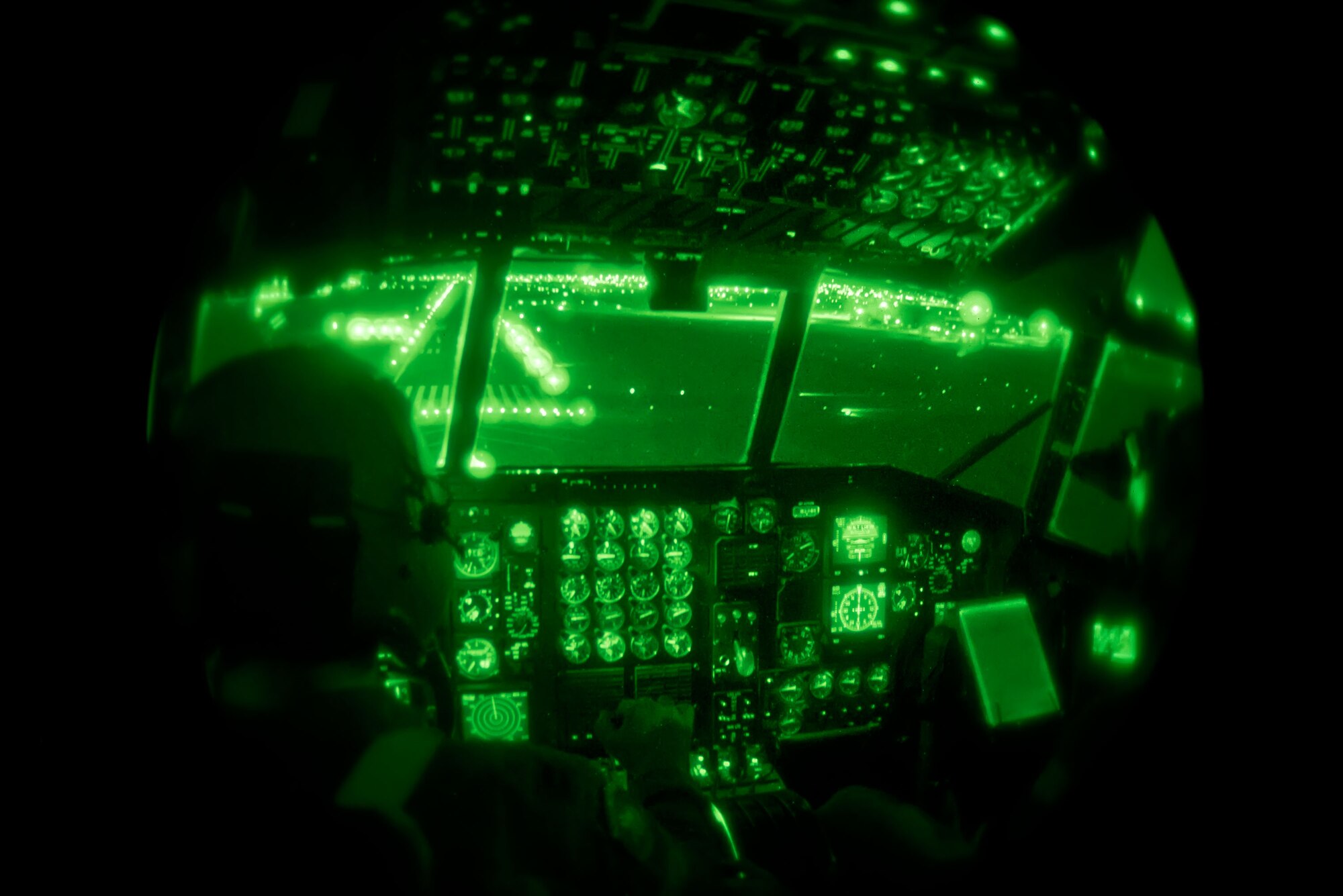 Capt. Andrew Reinhart and Lt. Col. Anthony Determan, 96th Airlift Squadron, use the night vision goggles to guide their runway approach at the Sioux Falls Airport, S.D., Saturday night. The weekend training missions for the 96th Airlift Squadron and 27th Aerial Port Squadron included preparing and deploying air drops, unscheduled landings, operating in night vision environment and deploying flares.  (U.S. Air Force photo by Shannon McKay/Released)