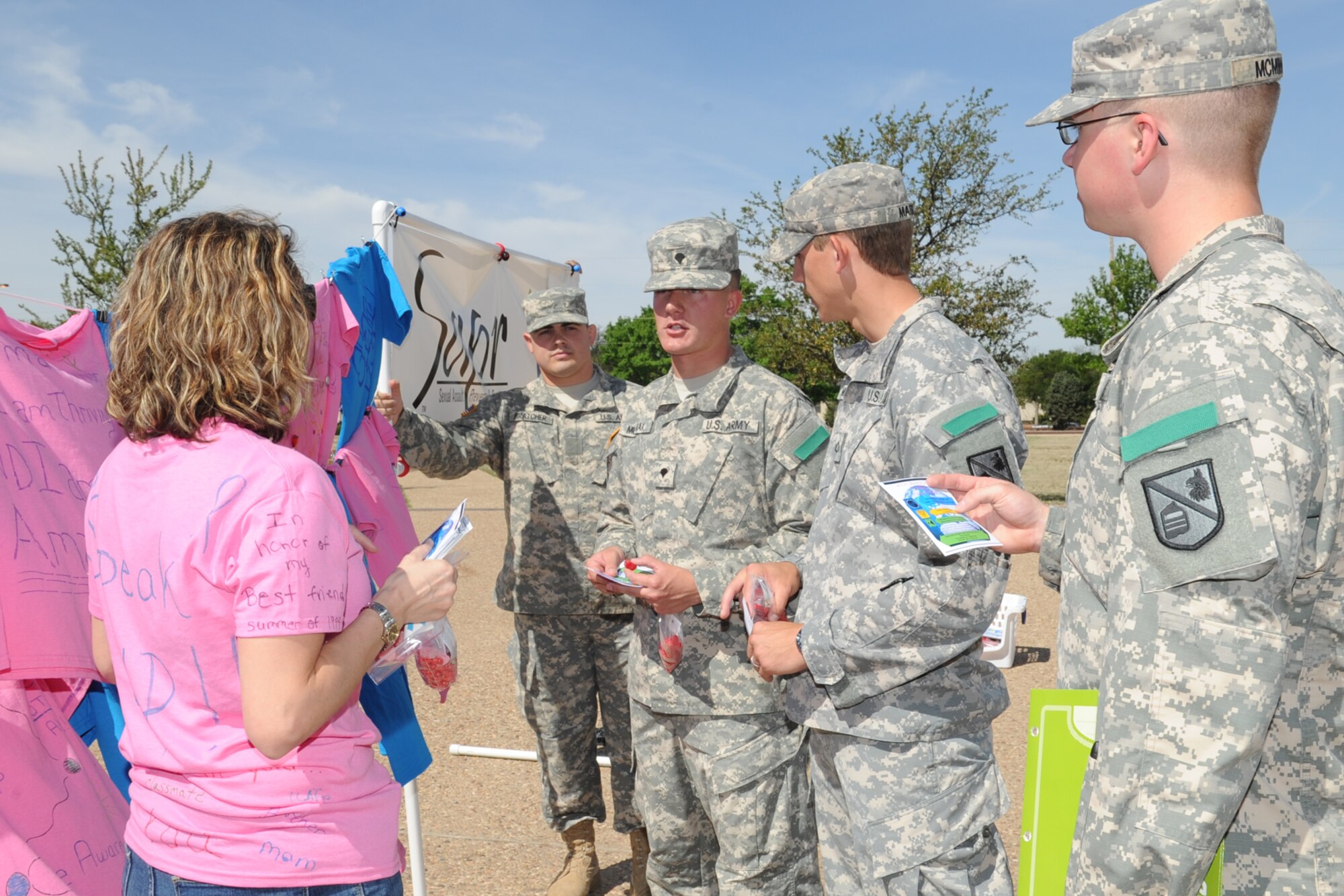 GOODFELLOW AIR FORCE BASE, Texas -- Donna L. Casey, 17th Training Wing sexual assault response coordinator, talks to Soldiers about the Clothesline Project promoting Sexual Assault Awareness Month here April 11. Sexual assault survivors or family members of survivors decorated t-shirts to tell their stories and the shirts were placed on a traveling clothesline. (U.S. Air Force photo/ Staff Sgt. Laura R. McFarlane)