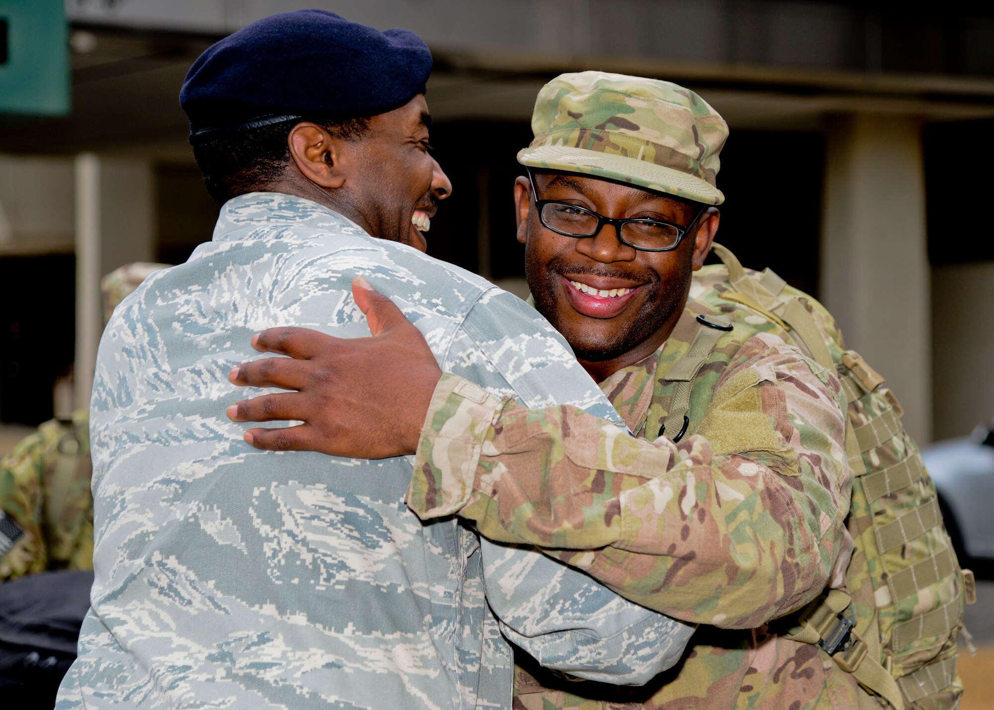 U.S. Air Force Tech. Sgt. Raymar Webb, 633d Security Forces Squadron unit deployment manager, greets Senior Airman Deandre Buggs, 633d SFS response force leader, upon arrival at Norfolk International Airport in Norfolk, Va., April 15, 2014. Twelve Airmen from the 633rd SFS spent six months in Bagram, Afghanistan, in support of Operation Enduring Freedom. (U.S. Air Force photo by Staff Sgt. Antoinette Gibson/Released)
