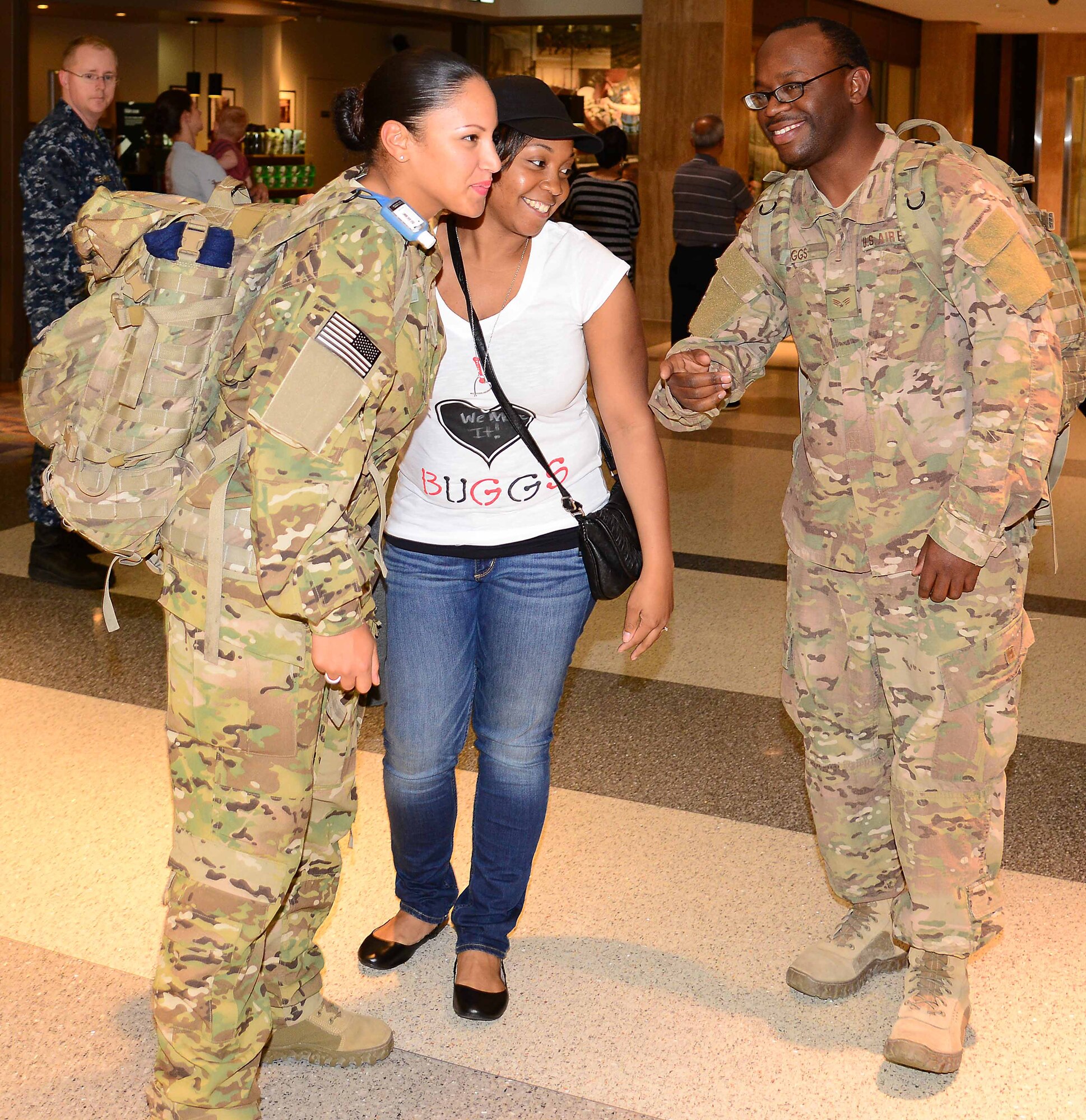 Destiny Perkins, girlfriend of U.S. Air Force Senior Airman Deandre Buggs, welcomes Airmen from the 633rd Security Forces Squadron home upon arrival at Norfolk International Airport in Norfolk, Va., April 15, 2014. The Airmen deployed to Bagram, Afghanistan Oct. 18, 2013, to provide base security operations in support of Operation Enduring Freedom. (U.S. Air Force photo by Staff Sgt. Antoinette Gibson/Released)