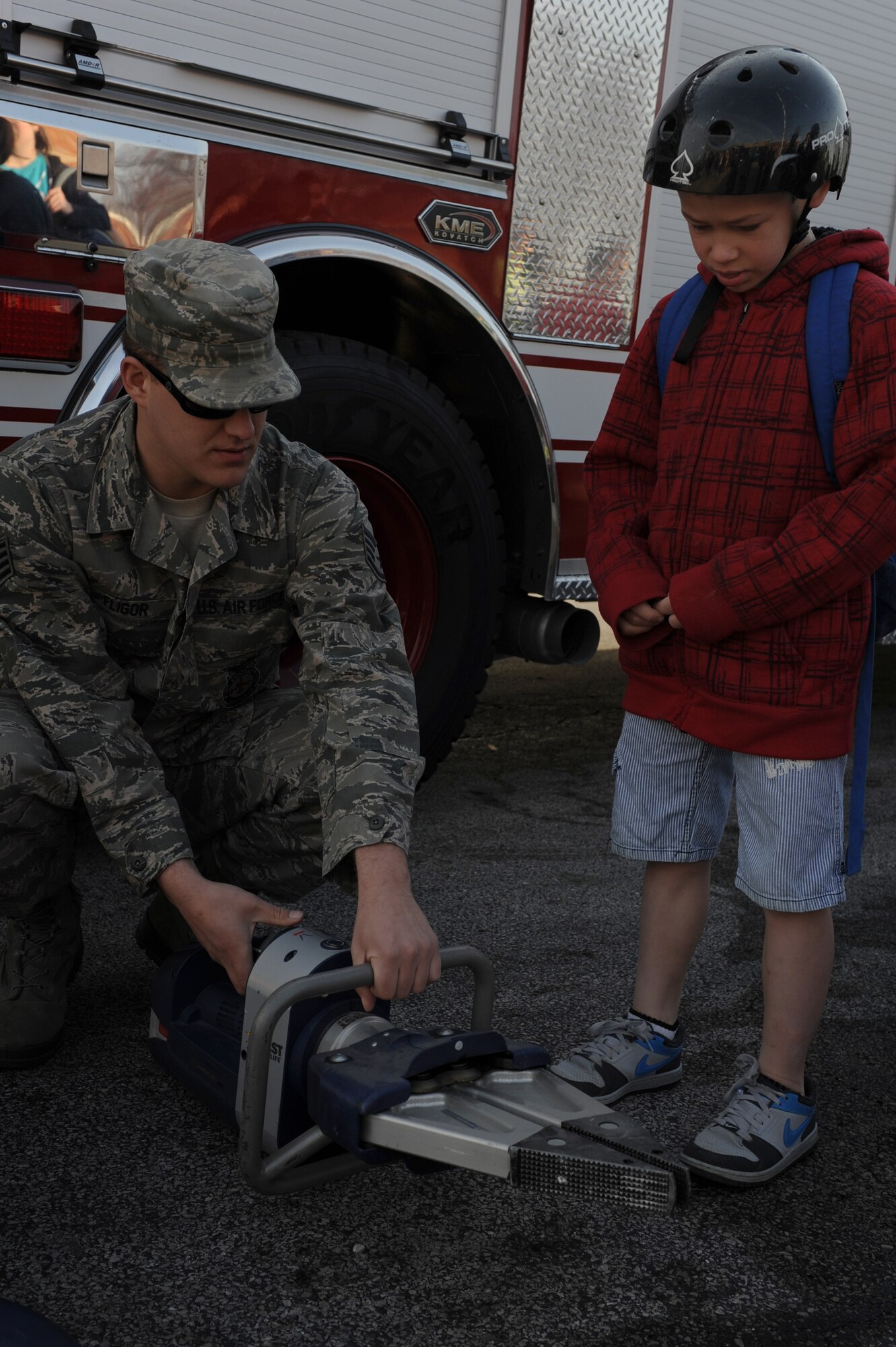 Staff Sgt. James Fligor, 375th Civil Engineer Squadron fire crew cheif, demonstrates the "jaws of life" to a Scott Elementary School student on April 11, 2014 at Scott Air Force Base, Ill. The demonstration was part of the Week of the Military Child. (U.S. Air Force photo/Senior Airman Sarah Hall-Kirchner)