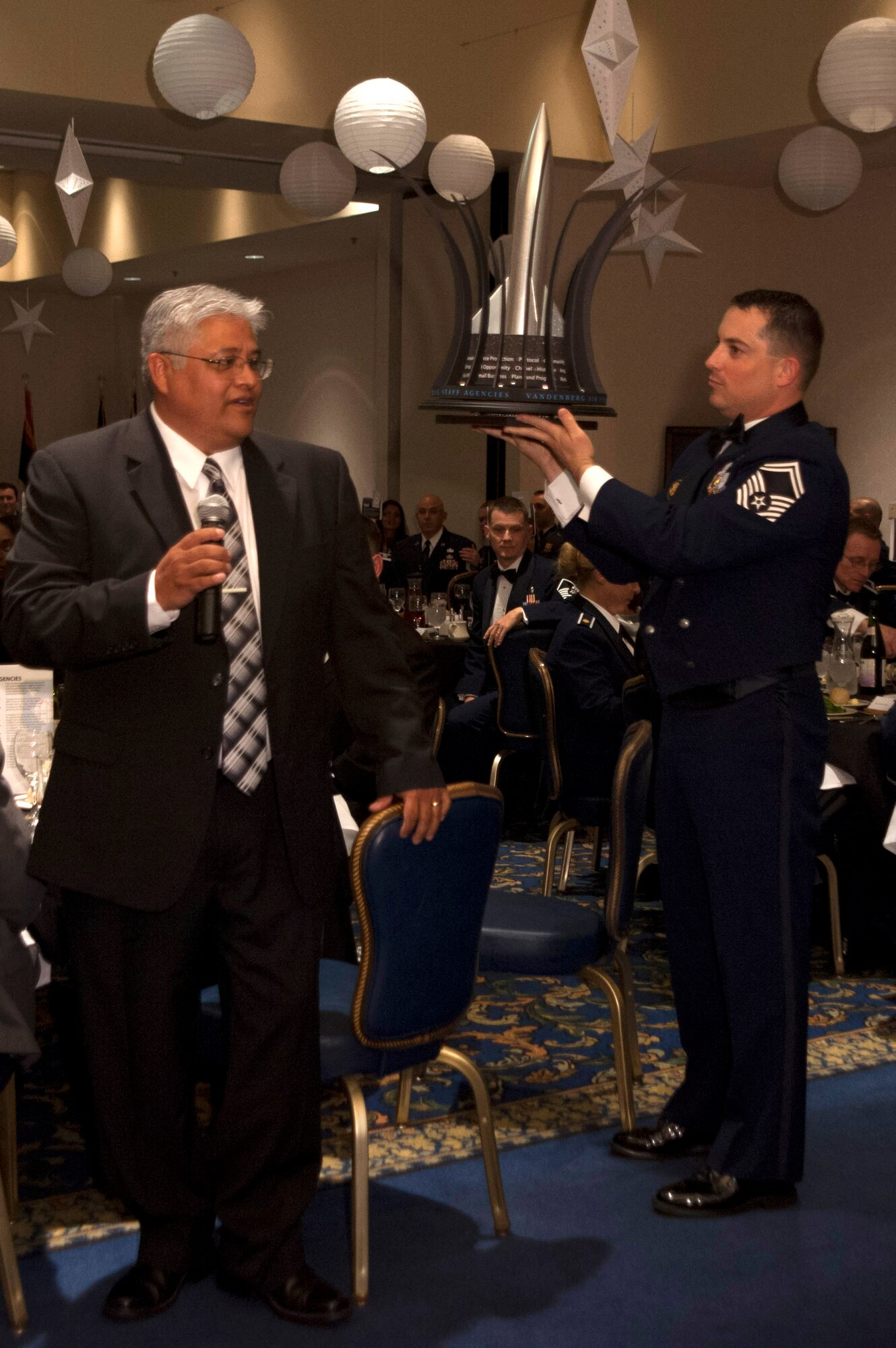 Units present their custom-made centerpieces during the 30th Space Wing Dining Out April 11, 2014, Vandenberg Air Force Base, Calif. The Dining Out was held to celebrate the 55th anniversary of space launches at Vandenberg. (U.S. Air Force photos/Airman 1st Class Yvonne Morales)