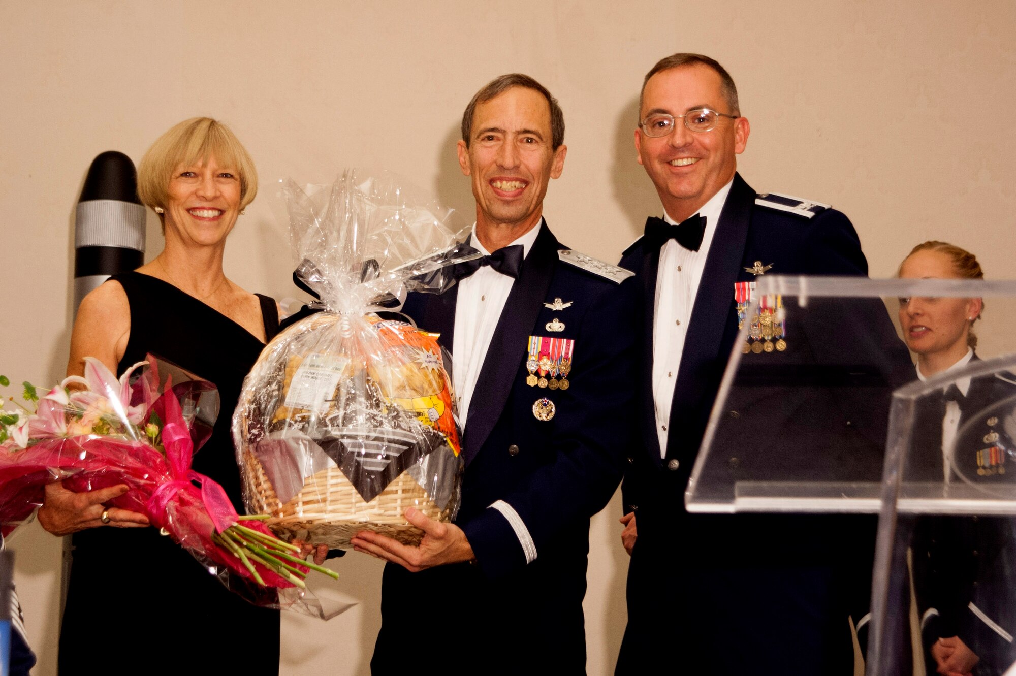 Guests of honor Lt. Gen. Larry James, former 14th Air Force commander, and his wife Susan, receive gifts presented by Col. Keith Balts, 30th Space Wing commander, during the Dining Out April 11, 2014, Vandenberg Air Force Base, Calif. Members from around the base embraced traditions as they celebrated the 55th anniversary of space launches from Vandenberg. (U.S. Air Force photos/Airman 1st Class Yvonne Morales)