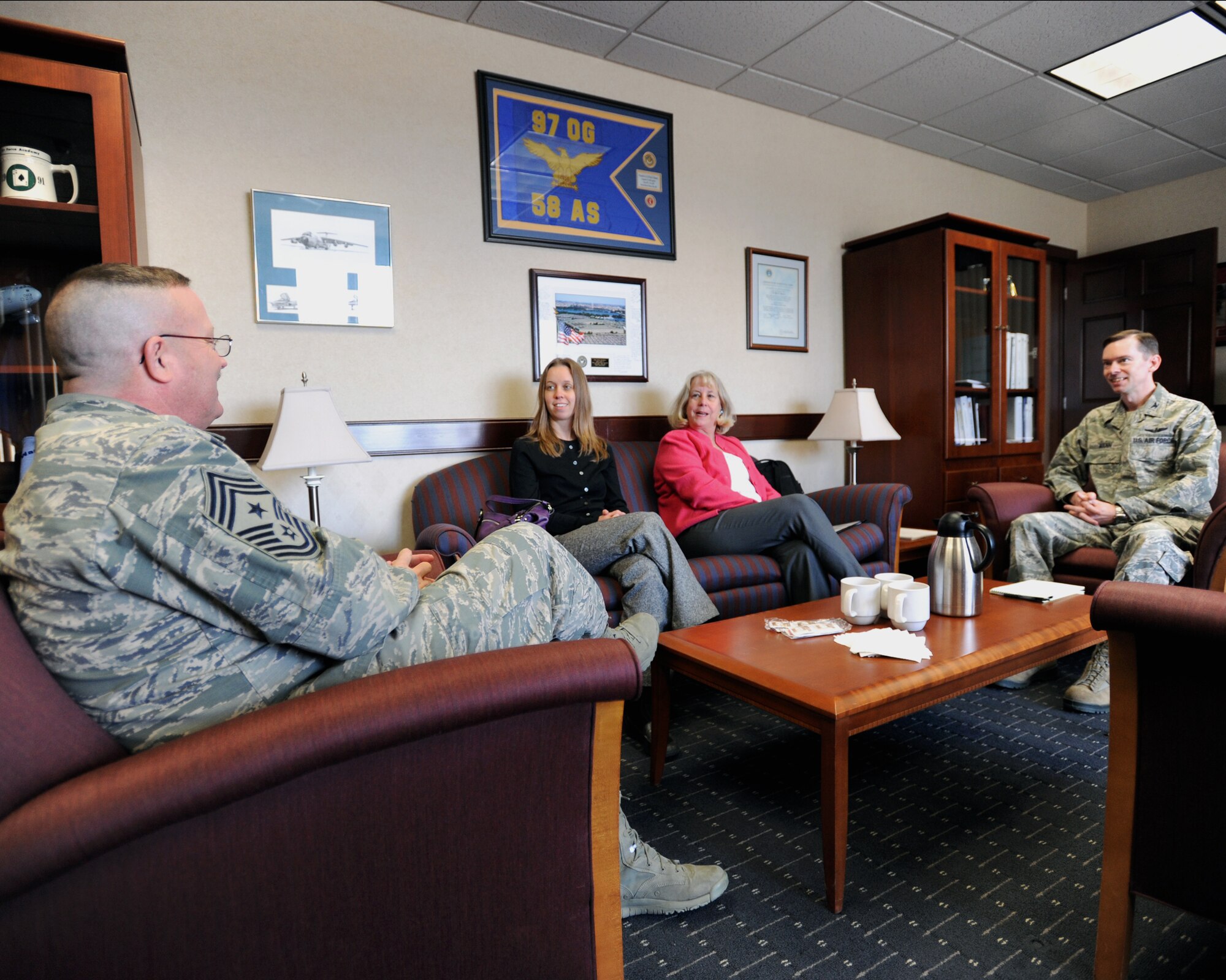 319th Air Base Wing Command Chief Master Sgt. David Duncan (left), Sarah Johnson, assistant for the First Lady of North Dakota, First Lady of North Dakota Betsy Dalrymple and Col. Christopher Mann, 319th ABW vice commander, discuss details of the ND Cares program April 15, 2014, on Grand Forks Air Force Base, N.D. The ND Cares program is a non-profit and volunteer-driven group for the state of North Dakota to fight veteran homelessness and suicide. The purpose of Dalrymple’s visit was to discuss if and how the base would participate in the quarterly meetings for ND Cares and what they could bring to the table. (U.S. Air Force photo/Senior Airman Zachiah Roberson)