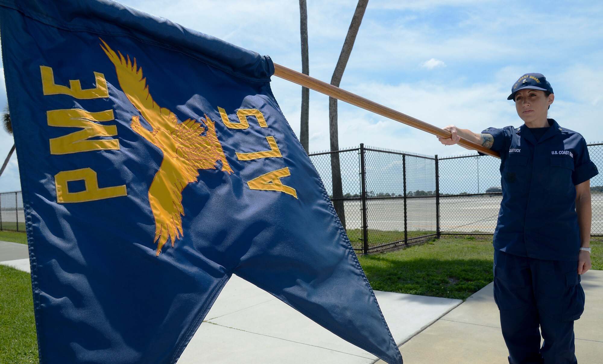 U.S. Coast Guard Petty Officer 3rd Class Staci Wantuck, stands at attention with the Airman Leadership School’s guidon at MacDill Air Force Base, Fla., April 11, 2014. During her time in ALS, Wantuck was the guidon bearer. (U.S. Air Force photo by Senior Airman Shandresha Mitchell/Released)