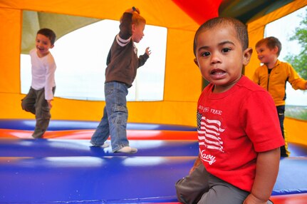 Twenty-one month old Jaiden Robinson greets visitors to the bouncy house at the inaugural Air Force Intelligence, Surveillance and Reconnaissance Agency Field Day and Family Picnic at Security Hill's Stapleton Park April 5. The event is the unit's way of saying thanks to all who have sacrificed on its behalf. (U. S. Air Force photo by William Belcher)