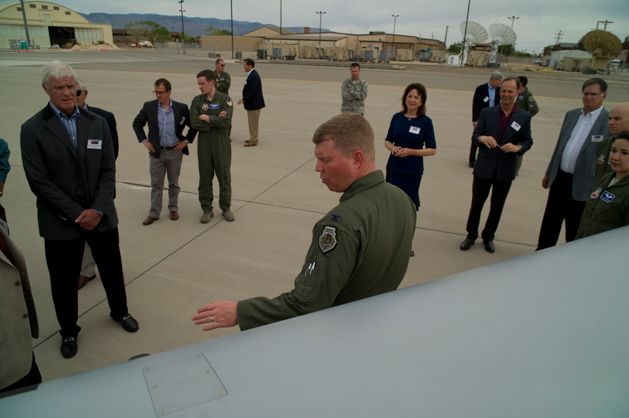 Colonel Andrew Croft, 49th Wing commander, describes the capabilities of an MQ-1 Predator Remotely Piloted Aircraft to members of the Business Executives for National Security group at Holloman Air Force Base, N.M., April 11. The Business Executives for National Security group visits one military installation per month to exchange ideas on common issues and to further public and private partnerships. The visit featured 49th Wing and Team Holloman missions. (U.S. Air Force photo by Airman 1st Class Aaron Montoya / Released)