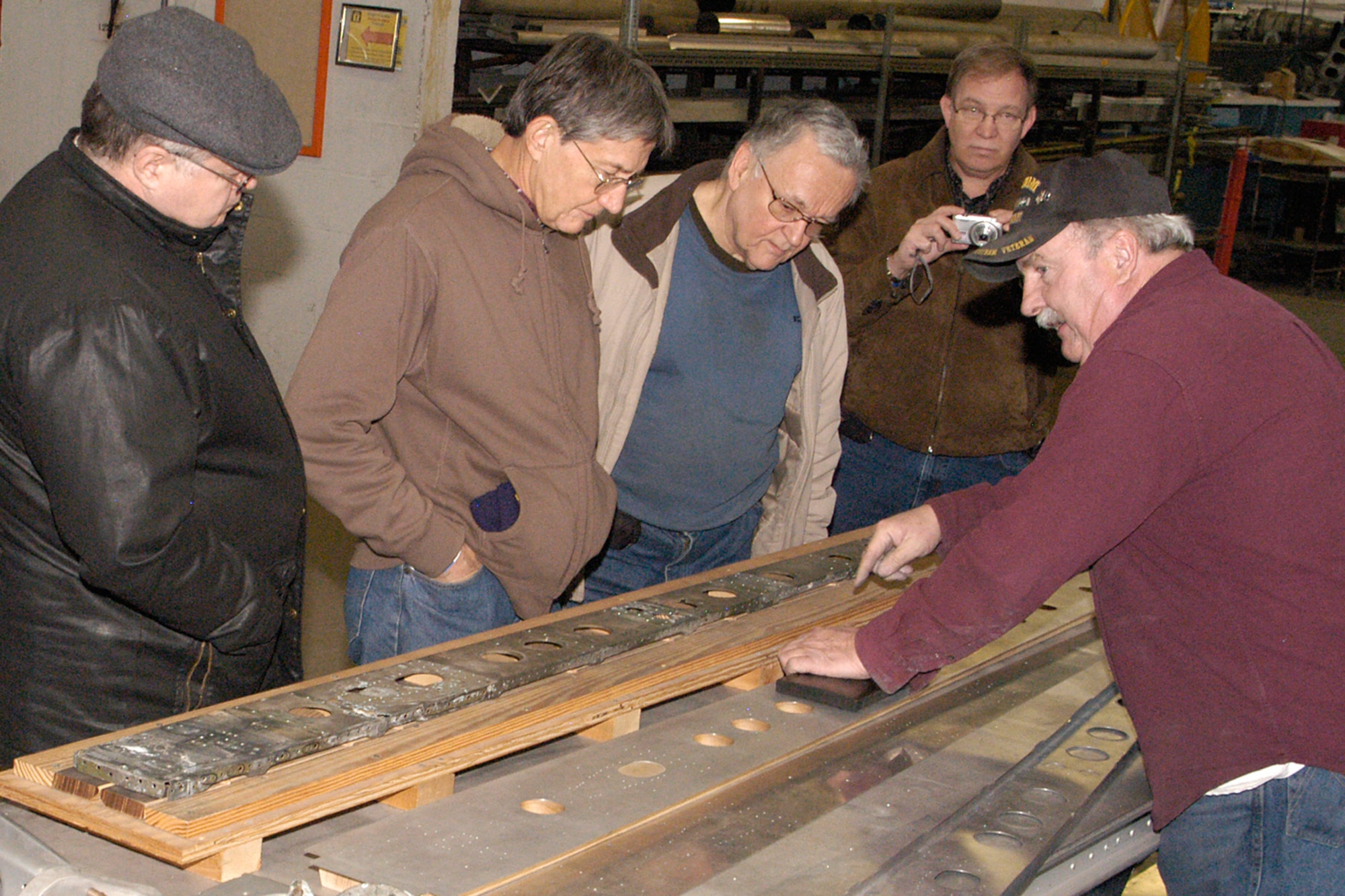 DAYTON, Ohio - Museum volunteer Tim Ward shows visitors restoration techniques during the Behind the Scenes Tour of the restoration area. (U.S. Air Force photo by Ken LaRock) 
