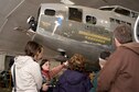 DAYTON, Ohio - Museum volunteer Beverly Smith walks visitors through the Behind the Scenes Tour of the restoration area. The Memphis Belle is one of the restoration projects that visitors can view. (U.S. Air Force photo by Ken LaRock) 
