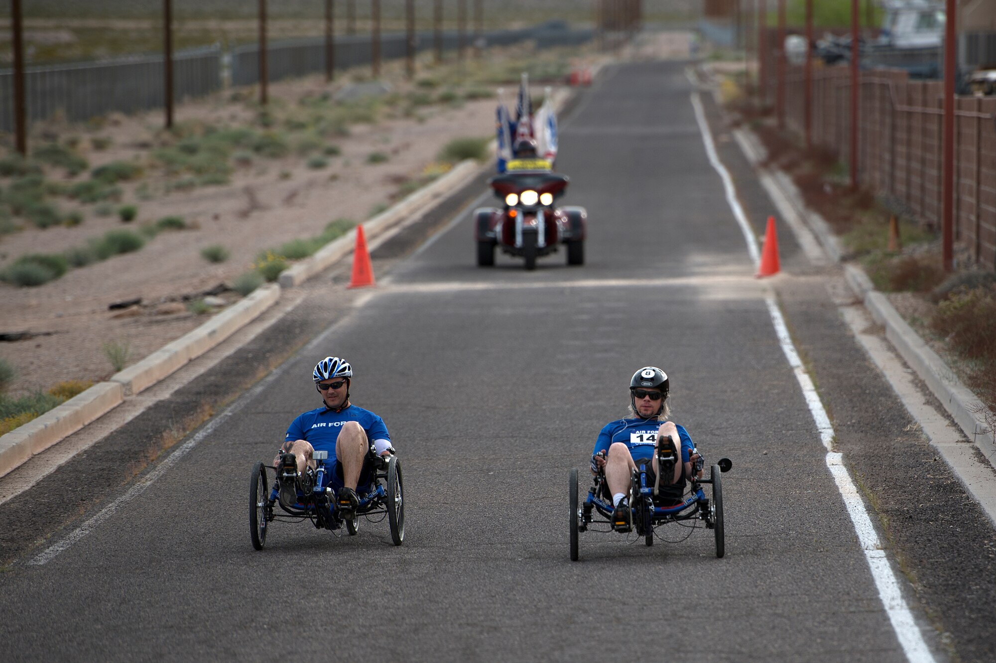 Athletes race to the finish during the men’s recumbent heat April 9, 2014, during the Air Force Trials at Nellis Air Force Base, Nev. During the trials, injured, ill and wounded Airmen compete in Paralympic-type events to identify which members will be selected for the Warrior Games and Invictus Games teams. (U.S. Air Force photo/Senior Airman Jette Carr)