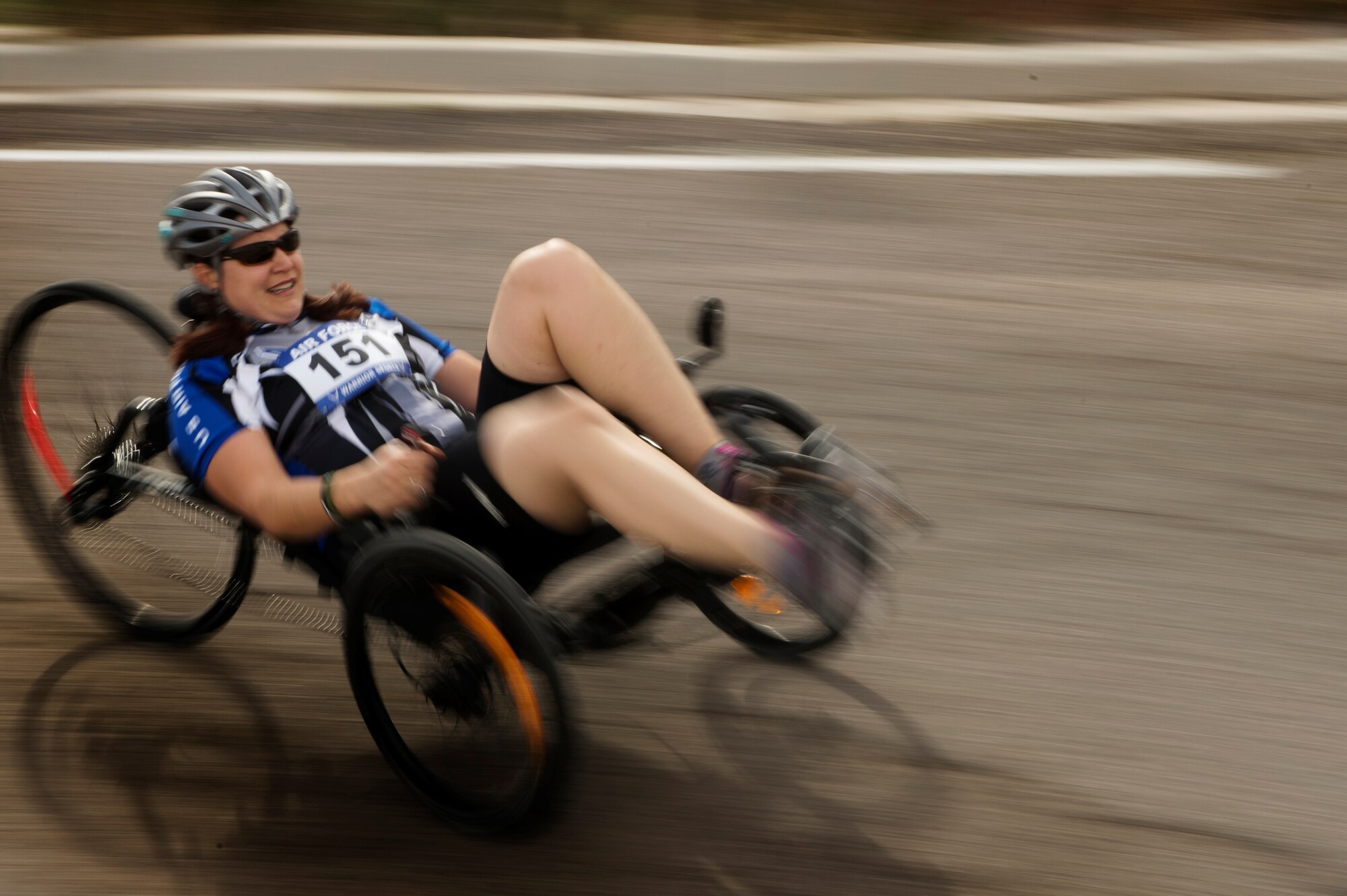 Jen Peters Kyseth sprints around a corner on a recumbent bike April 9, 2014, during the cycling portion of the Air Force Trials at Nellis Air Force Base, Nev. Kyseth competed with other wounded warriors for a place on a team for the Warrior Games or Invictus Games. (U.S. Air Force photo/Senior Airman Jette Carr)