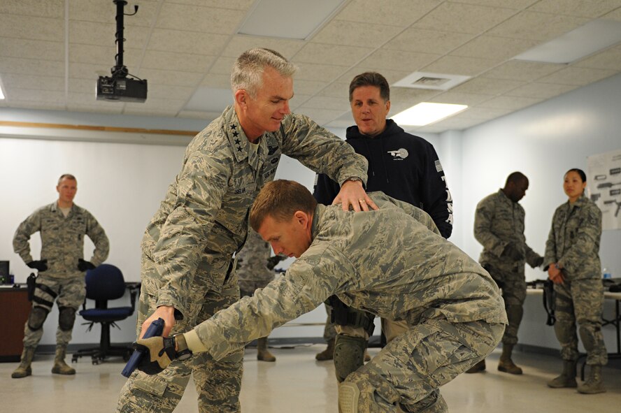 Gen. Paul Selva, Air Mobility Command commander, practices combatives moves on a participant during a security forces training session at Scott Air Force Base, Ill. on April 10, 2014. Selva attended some of the training sessions during a week-long training aimed at higher training standards. (U.S. Air Force photo/Senior Airman Sarah Hall-Kirchner)