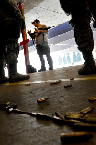 Security Forces Squadron Airmen and law enforcement members receive training on safe weapons handling procedures during Progressive Combat Solutions training at Scott Air Force Base, Ill., April 8, 2014. The Progressive Combat Solutions trains military and law enforcement personnel in decision making process originally benchmarked by the Air Force known as observe, orient, decide and act. The Air Mobility Command and the 375th Security Force Squadron hosted this training with the goal of implementing it across the AMC command in the future. (U.S. Air Force photo/Airman 1st Class Kiana Brothers)