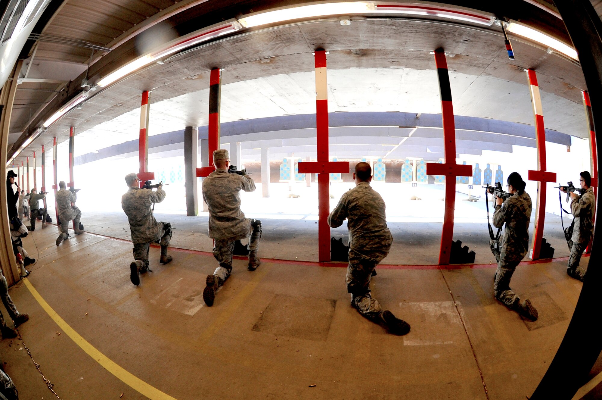 Security Forces Squadron Airmen and law enforcement members receive training on safely firing weapons at enemies during Progressive Combat Solutions training at Scott Air Force Base, Ill., April 8, 2014. The Progressive Combat Solutions trains military and law enforcement personnel in decision making process originally benchmarked by the Air Force known as observe, orient, decide and act. The Air Mobility Command and the 375th Security Force Squadron hosted this training with the goal of implementing it across the AMC command in the future. (U.S. Air Force photo/Airman 1st Class Kiana Brothers)