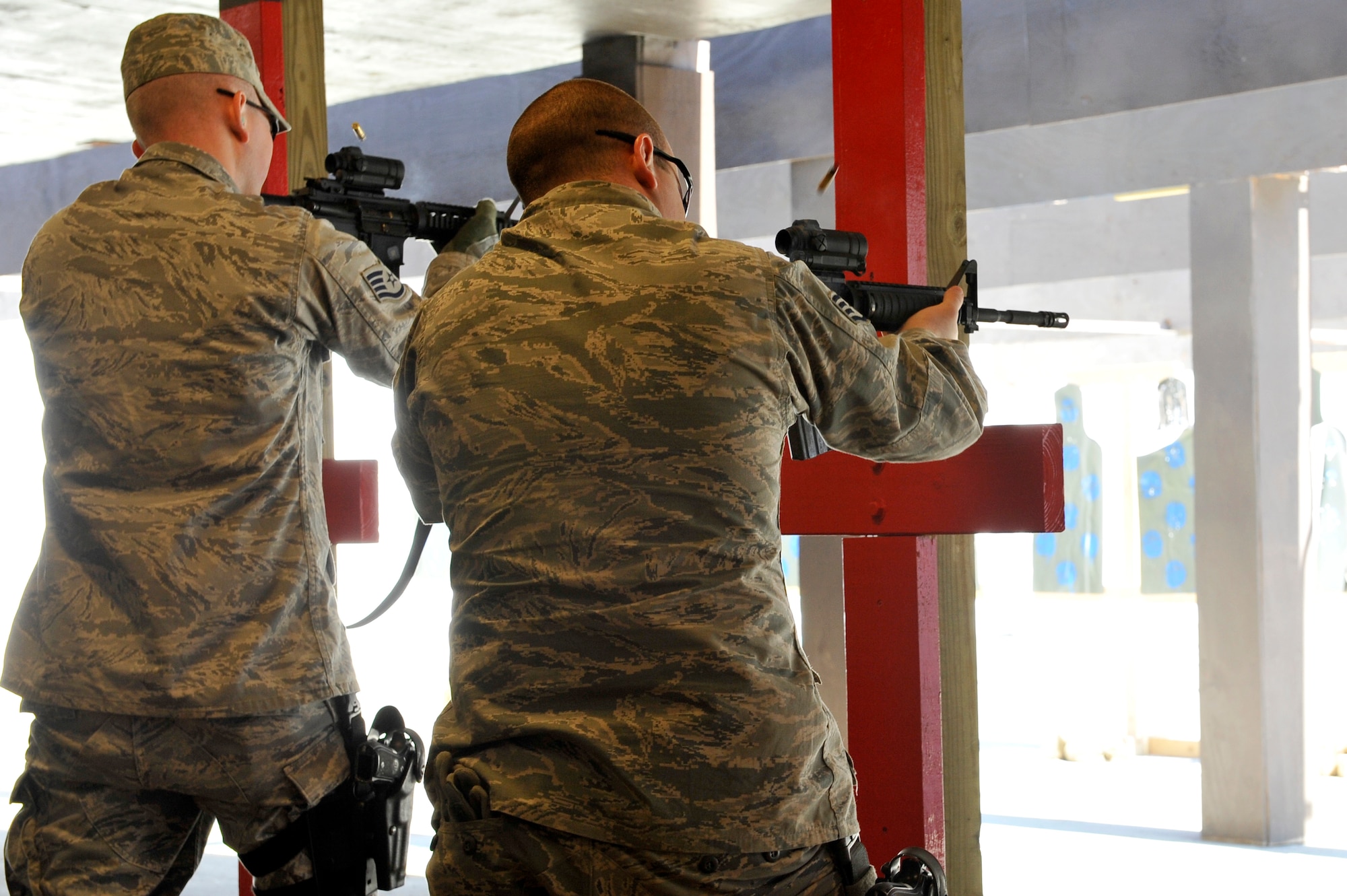 Security Forces Squadron Airmen and law enforcement members learn different techniques for firing during Progressive Combat Solutions training at Scott Air Force Base, Ill., April 8, 2014.The Progressive Combat Solutions trains military and law enforcement personnel in decision making process originally benchmarked by the Air Force known as observe, orient, decide and act. The Air Mobility Command and the 375th Security Force Squadron hosted this training with the goal of implementing it across the AMC command in the future. (U.S. Air Force photo/Airman 1st Class Kiana Brothers)