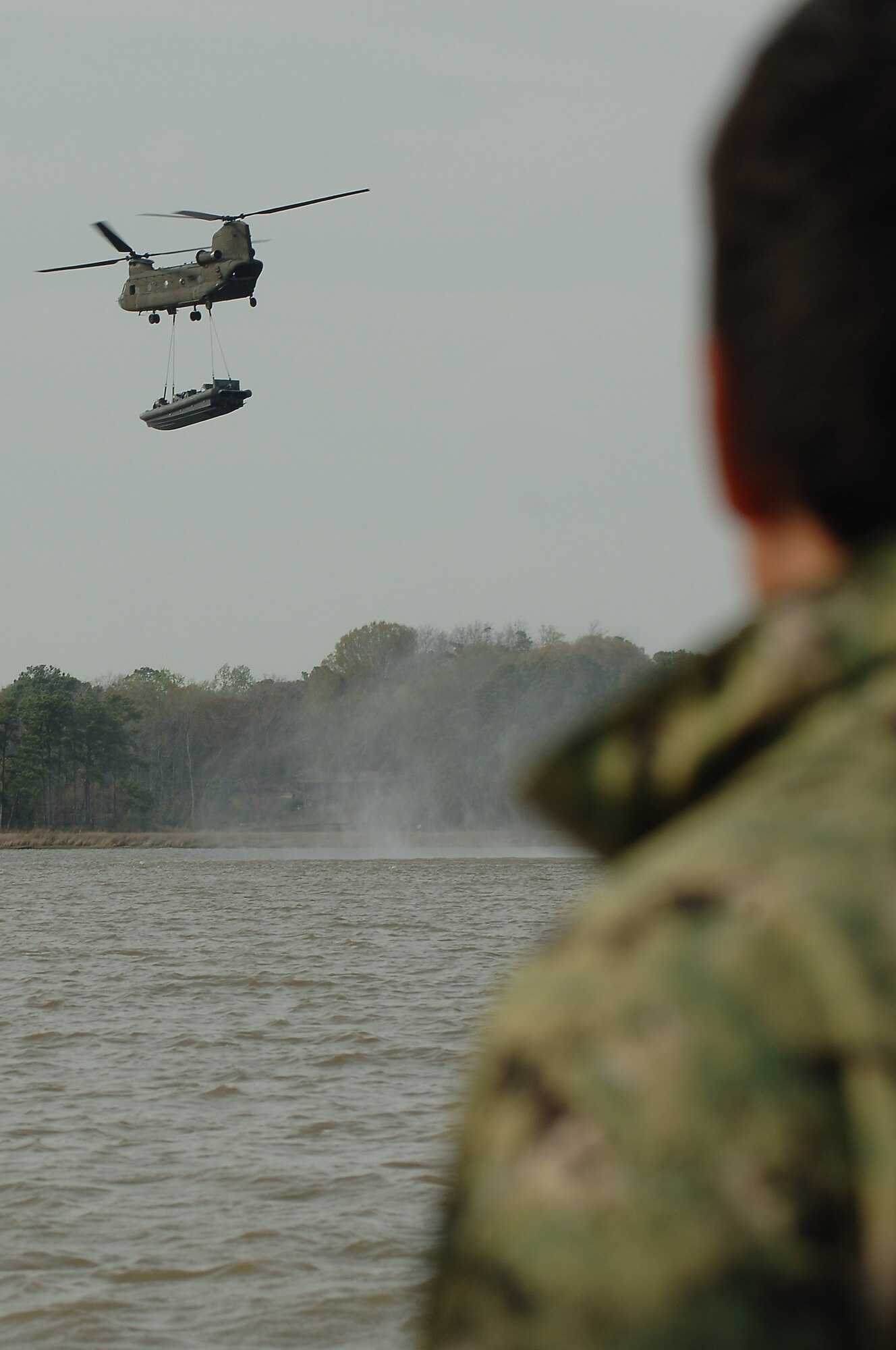 A 5-159th General Support Aviation Battalion CH-47 Chinook carries a U.S. Navy rigid-hull inflatable boat during a training exercise at Fort Eustis, Va., April 11, 2014. Throughout the five-day-long exercise, The 5-159th GSAB conducted 12 flights. (U.S. Air Force photo by Senior Airman Teresa J.C. Aber/Released) 