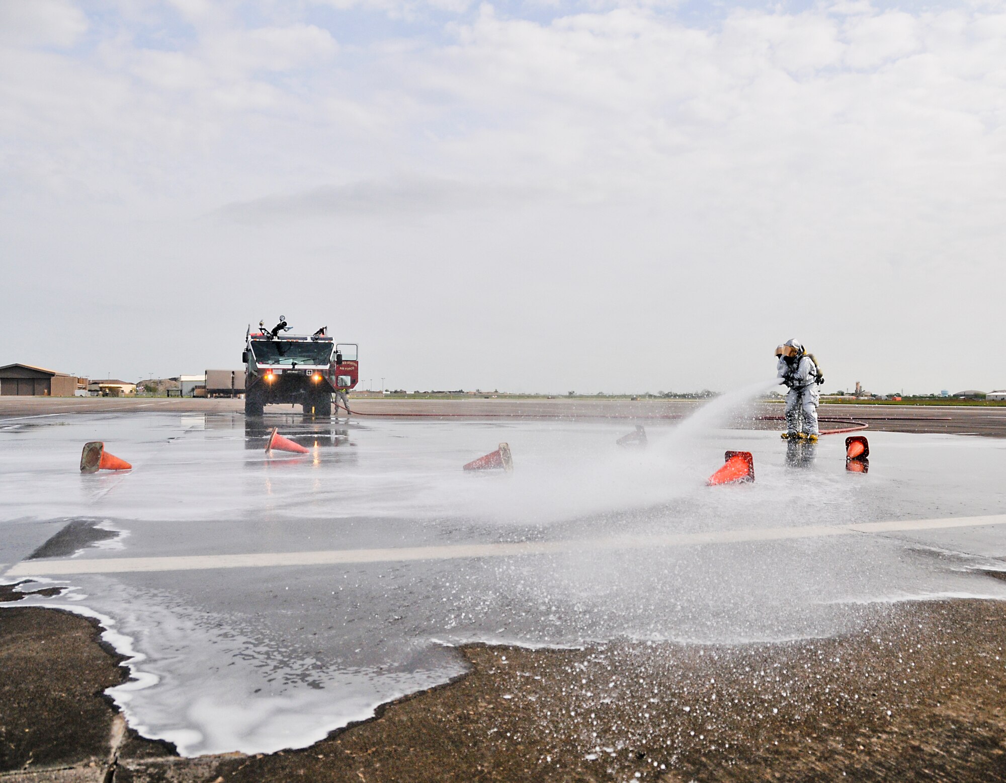 Members from the 147th Reconnaissance Wing Fire Department respond to a simulated aircraft fire while participating in an Operational Readiness Exercise at Ellington Field JRB, Houston, April 5, 2014. The firefighters were evaluated on their speed and accuracy of response during mock war-time activities.