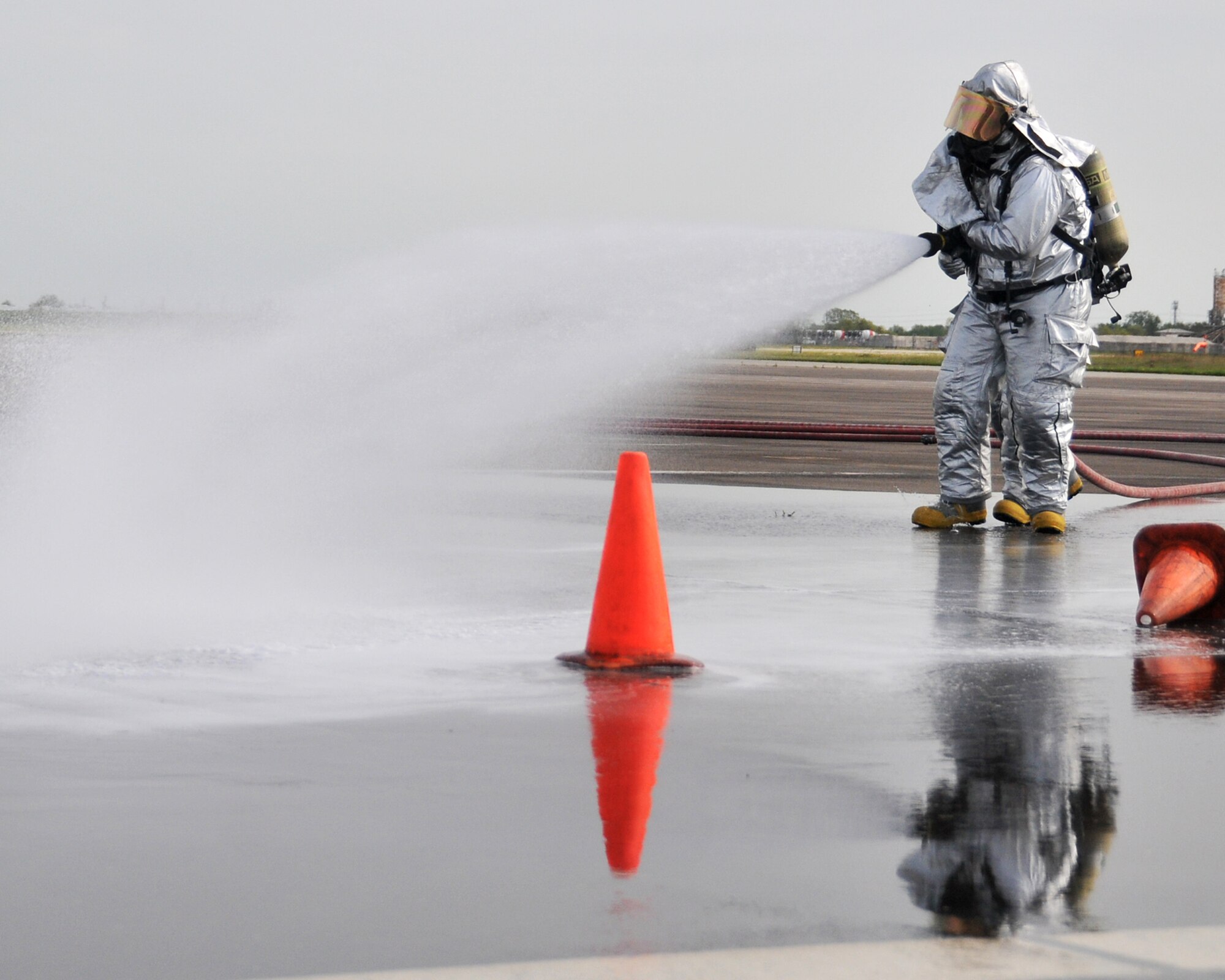 Members from the 147th Reconnaissance Wing Fire Department respond to a simulated aircraft fire while participating in an Operational Readiness Exercise at Ellington Field JRB, Houston, April 5, 2014. The firefighters were evaluated on their speed and accuracy of response during mock war-time activities.