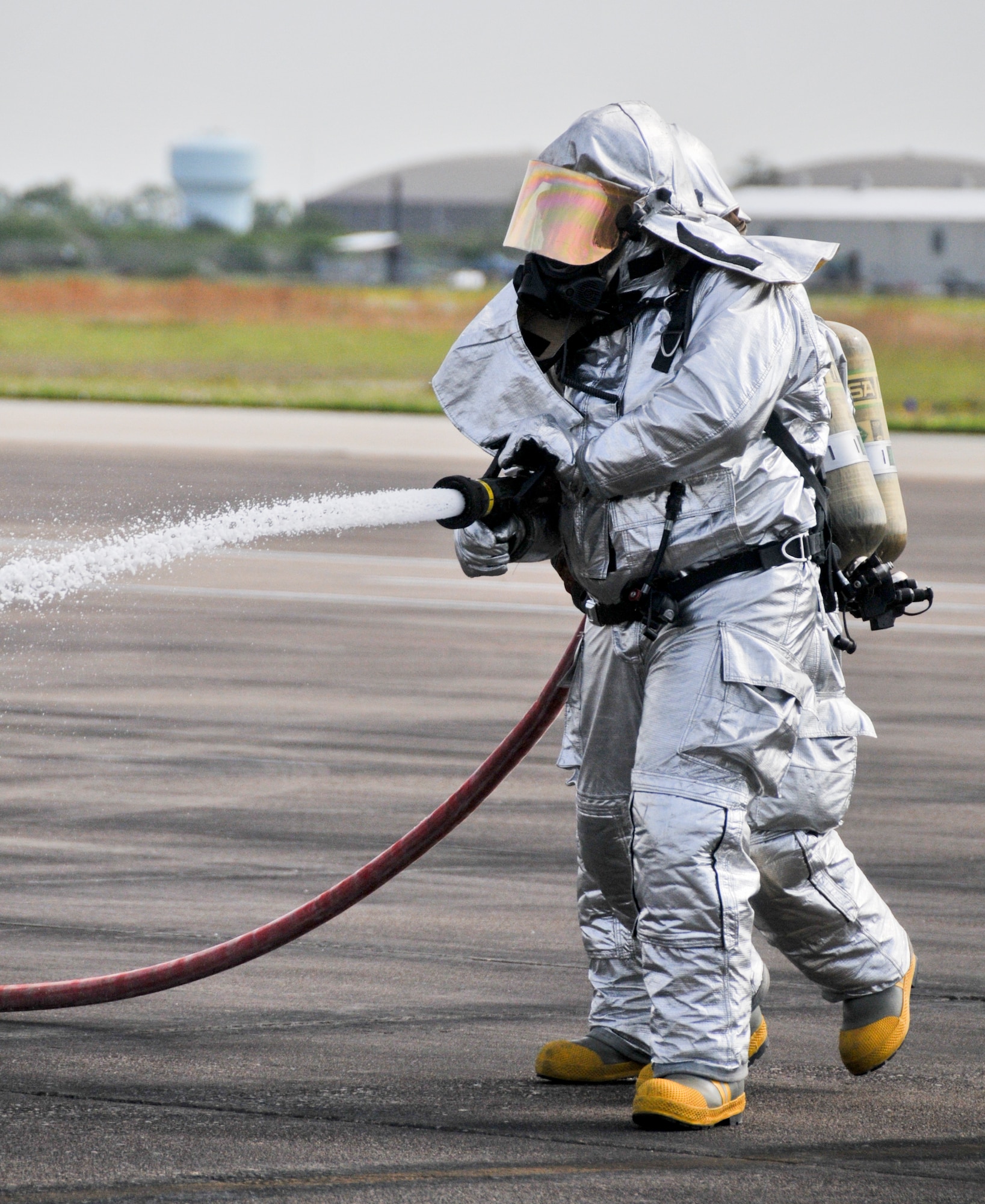 Members from the 147th Reconnaissance Wing Fire Department respond to a simulated aircraft fire while participating in an Operational Readiness Exercise at Ellington Field JRB, Houston, April 5, 2014. The firefighters were evaluated on their speed and accuracy of response during mock war-time activities.