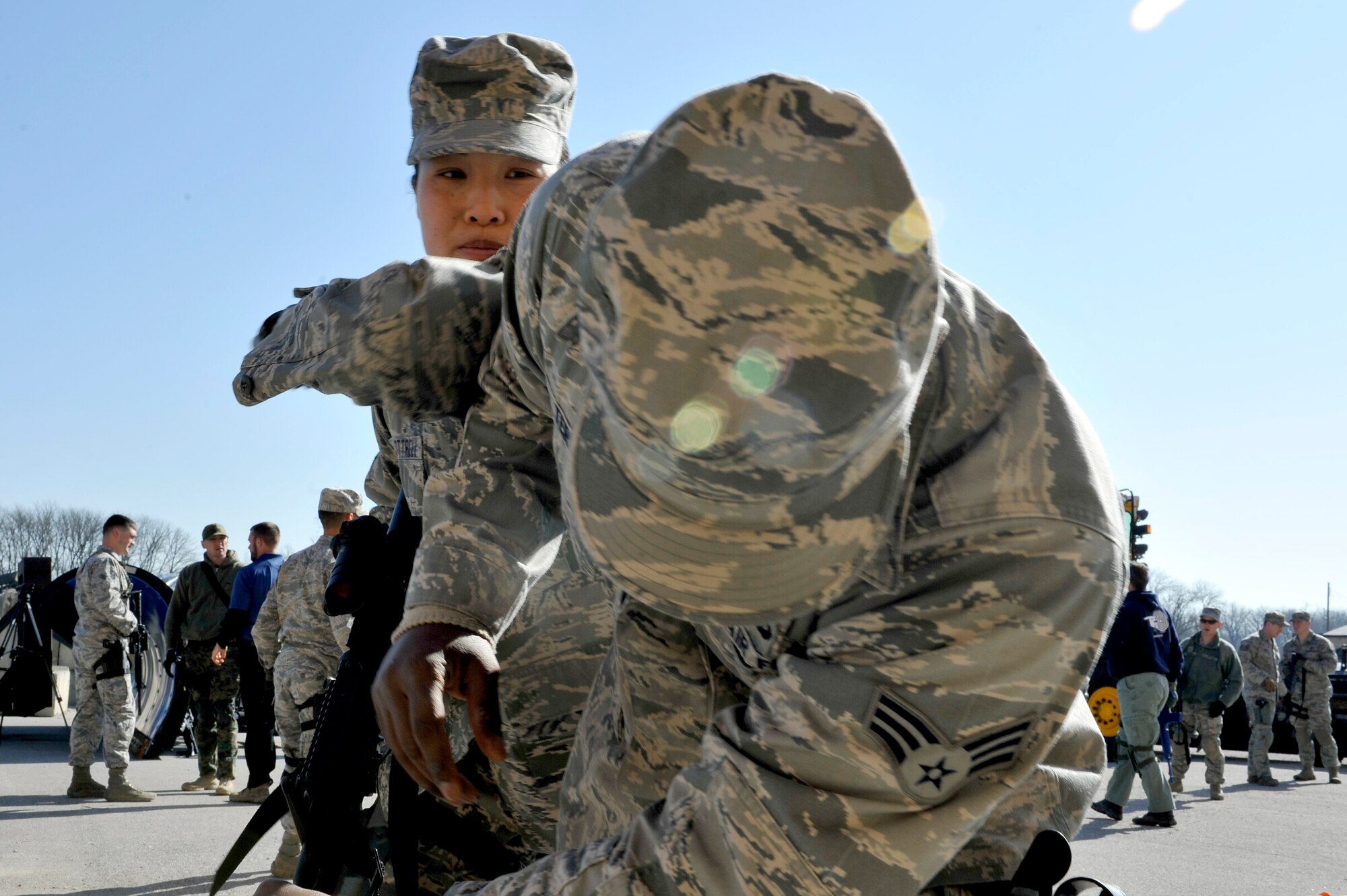 Security Forces Squadron trainers practice defense tactics during Progressive Combat Solutions training at Scott Air Force Base, Ill., April 8, 2014. The Progressive Combat Solutions trains military and law enforcement personnel in decision making process originally benchmarked by the Air Force known as observe, orient, decide and act. The Air Mobility Command and the 375th Security Force Squadron hosted this training with the goal of implementing it across the AMC command in the future. (U.S. Air Force photo/Airman 1st Class Kiana Brothers)